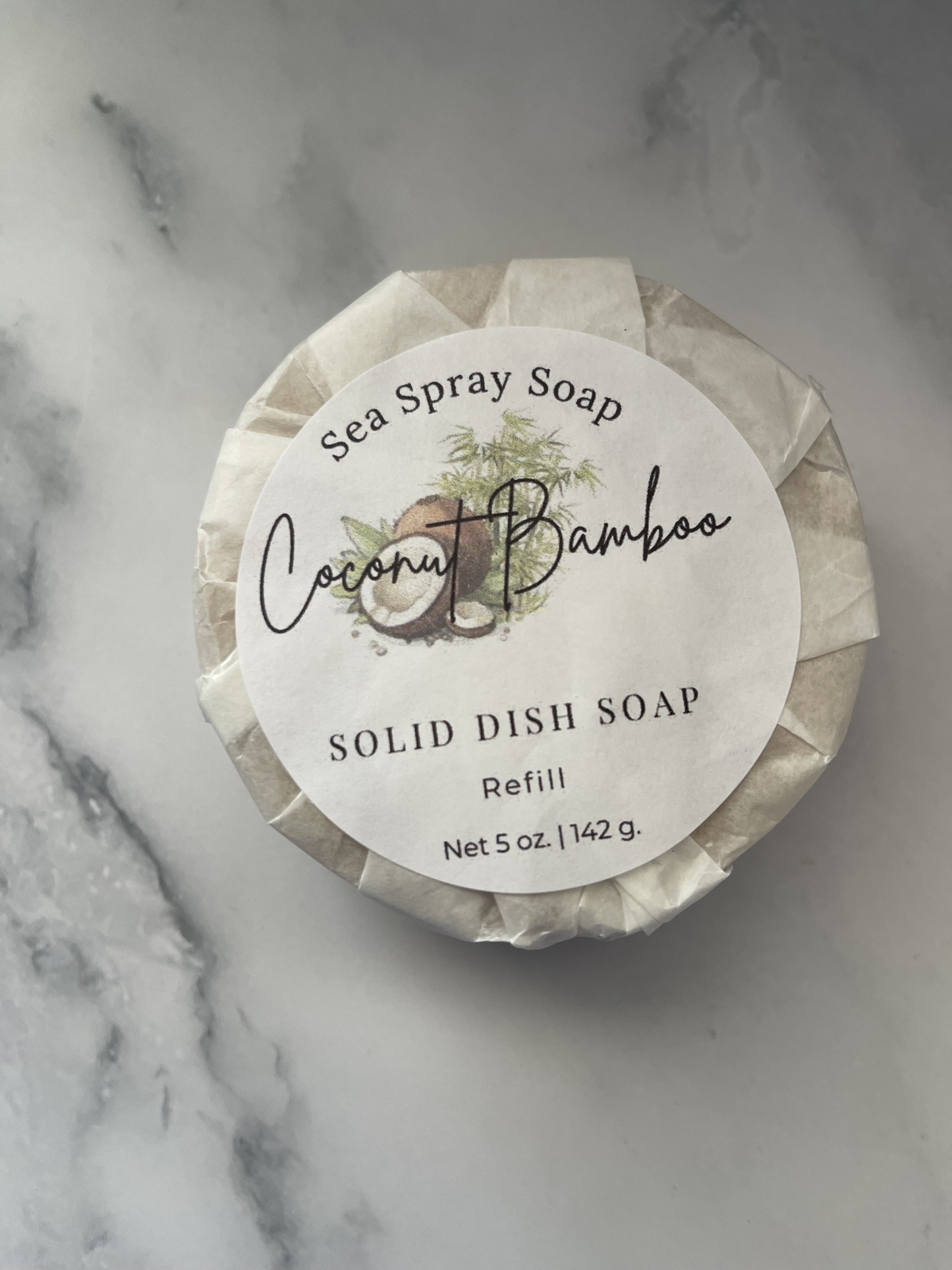 Solid dish soap refill with 'Coconut Bamboo' label on a marble surface