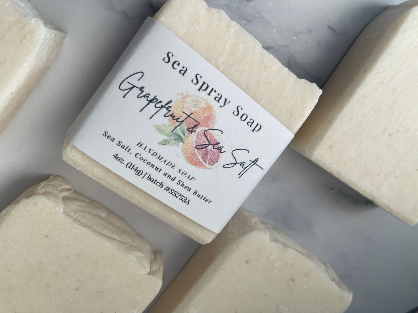 Bar of soap with a label on a marble surface