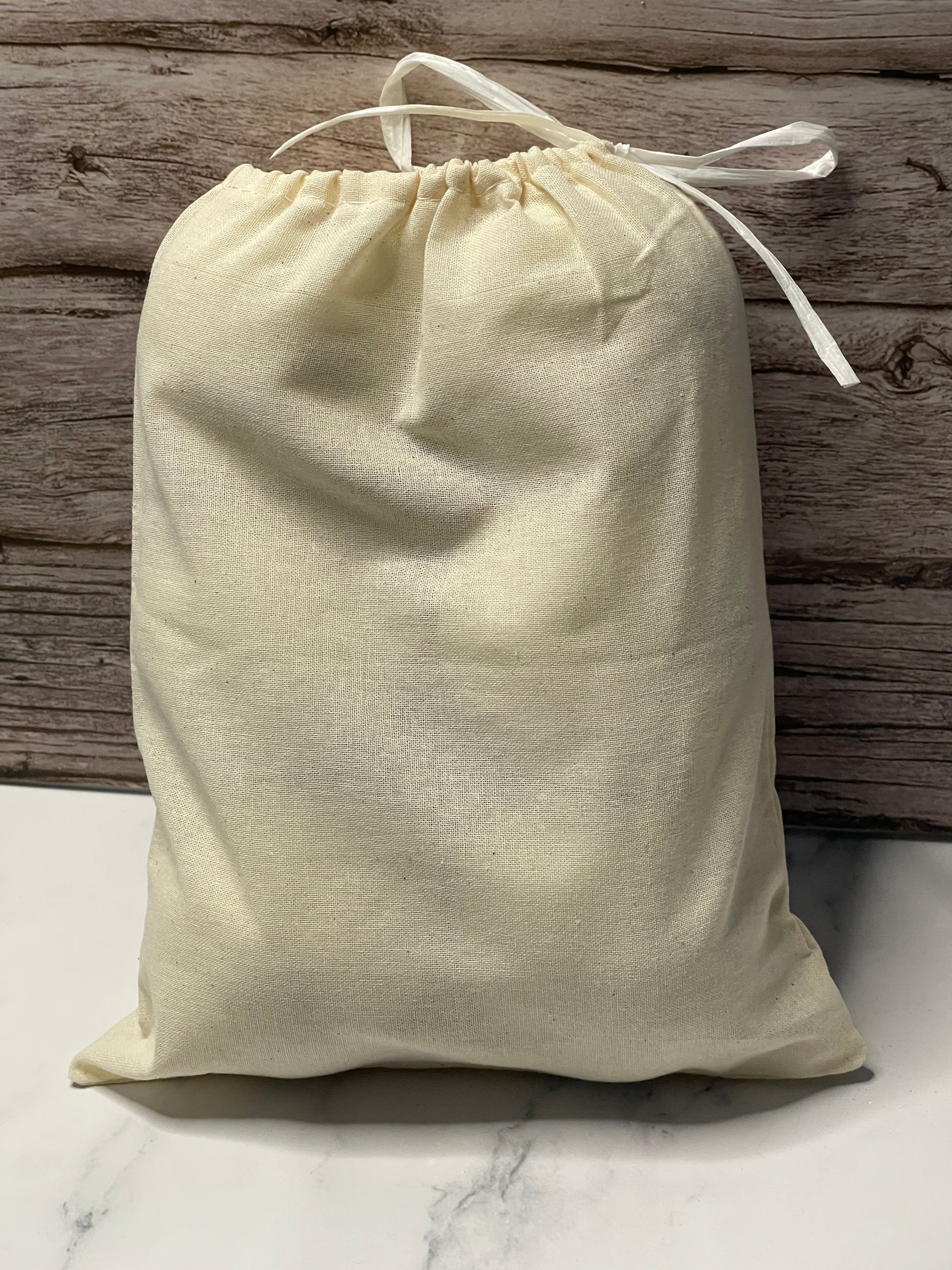 Beige drawstring bag on a wooden surface