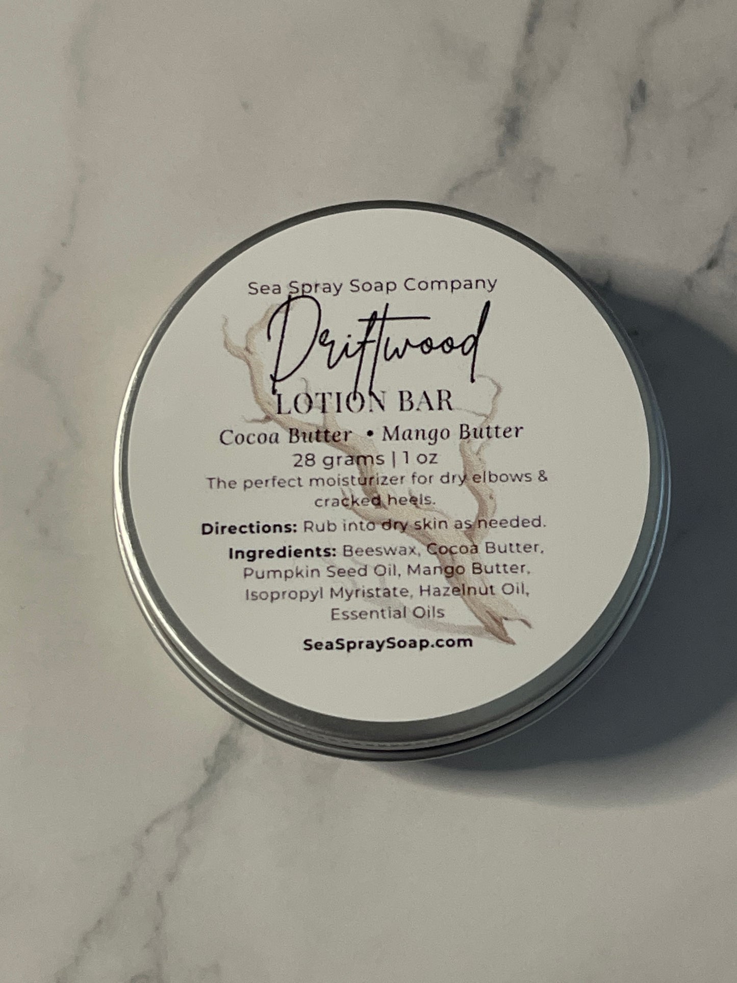 Lotion bar packaging with label on a marble surface