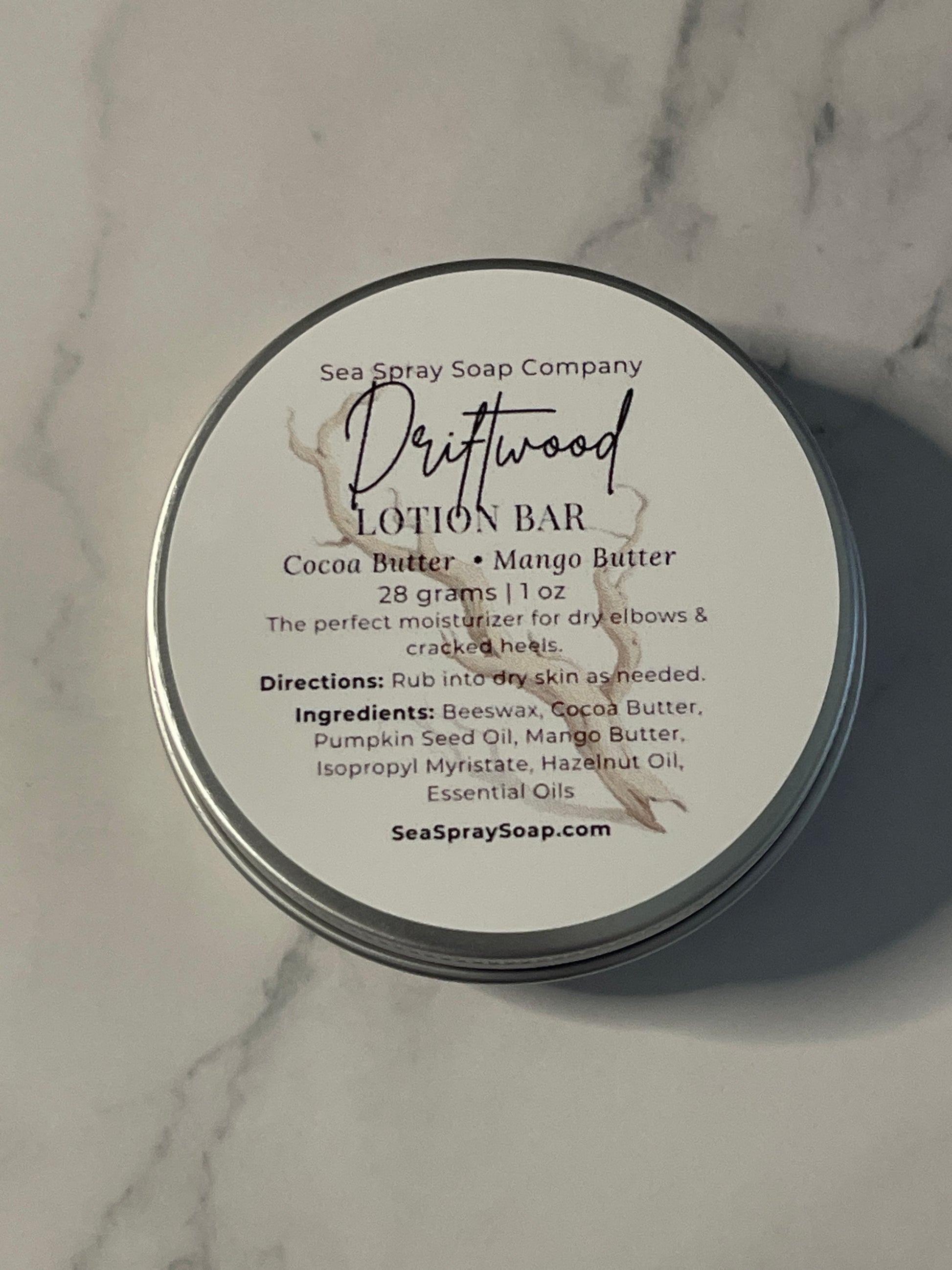 Lotion bar packaging with label on a marble surface