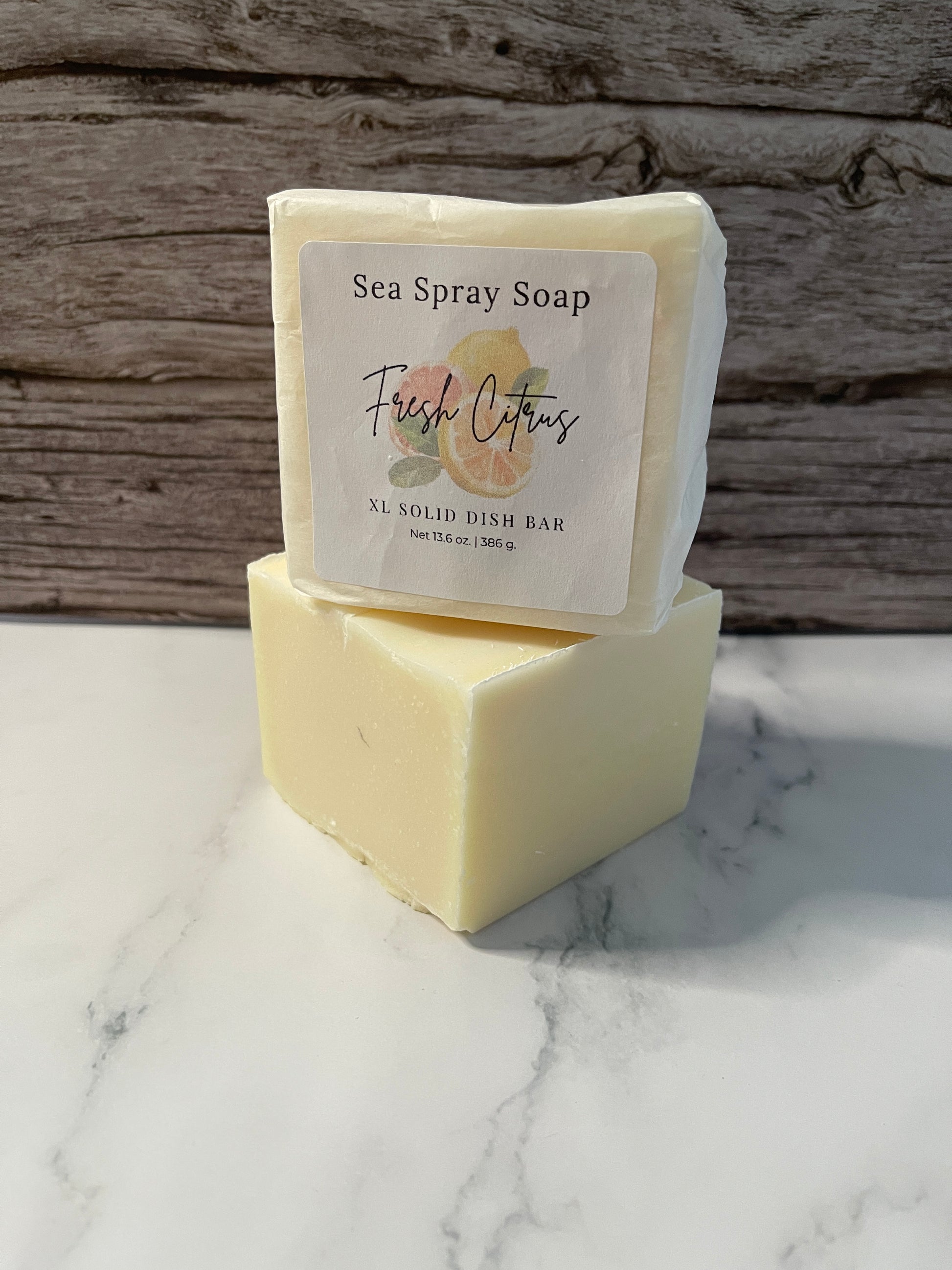Bar of soap with a label on a wooden and marble surface