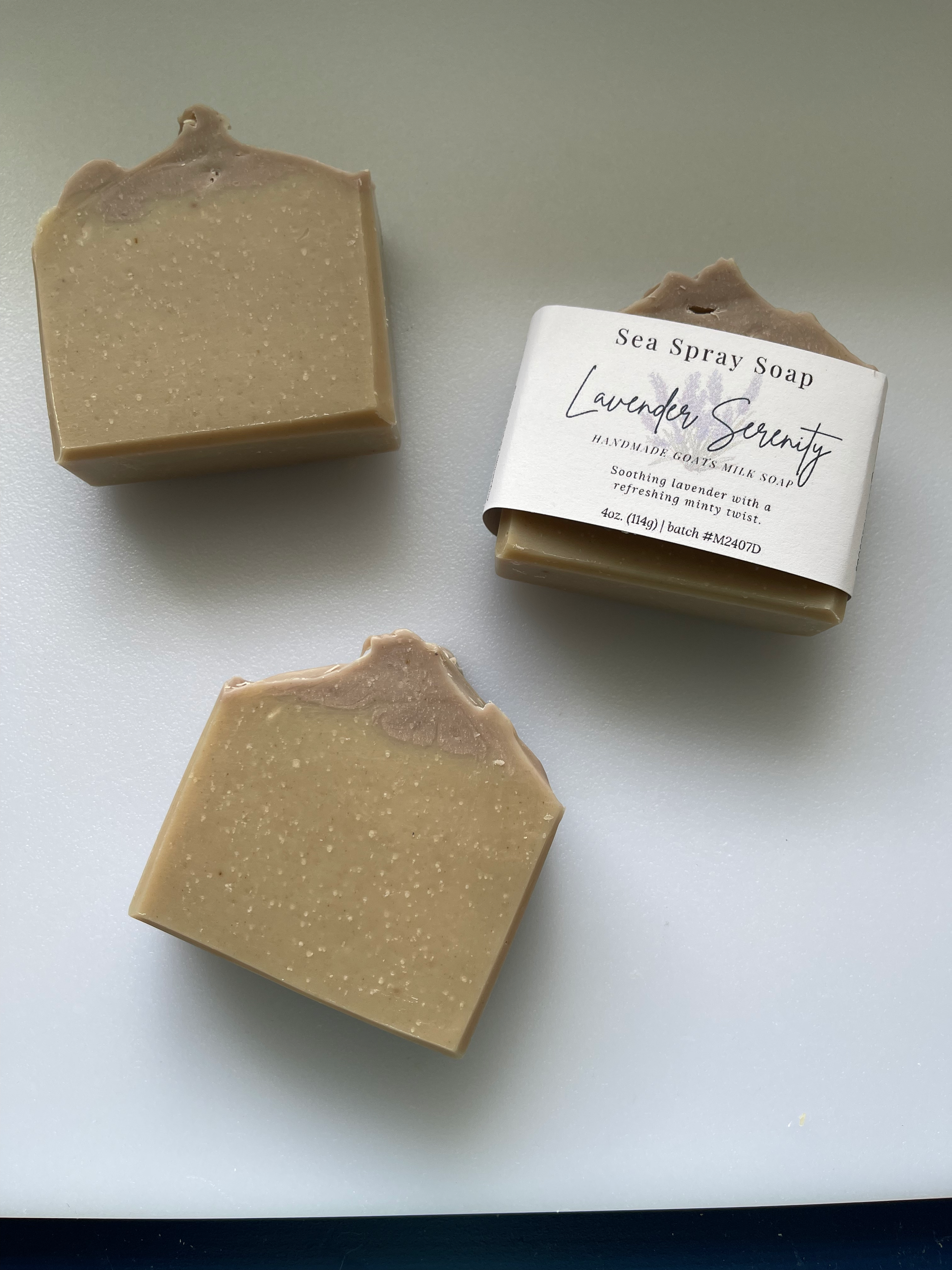 Two bars of soap and a box labeled 'Sea Spray Soap' on a light background