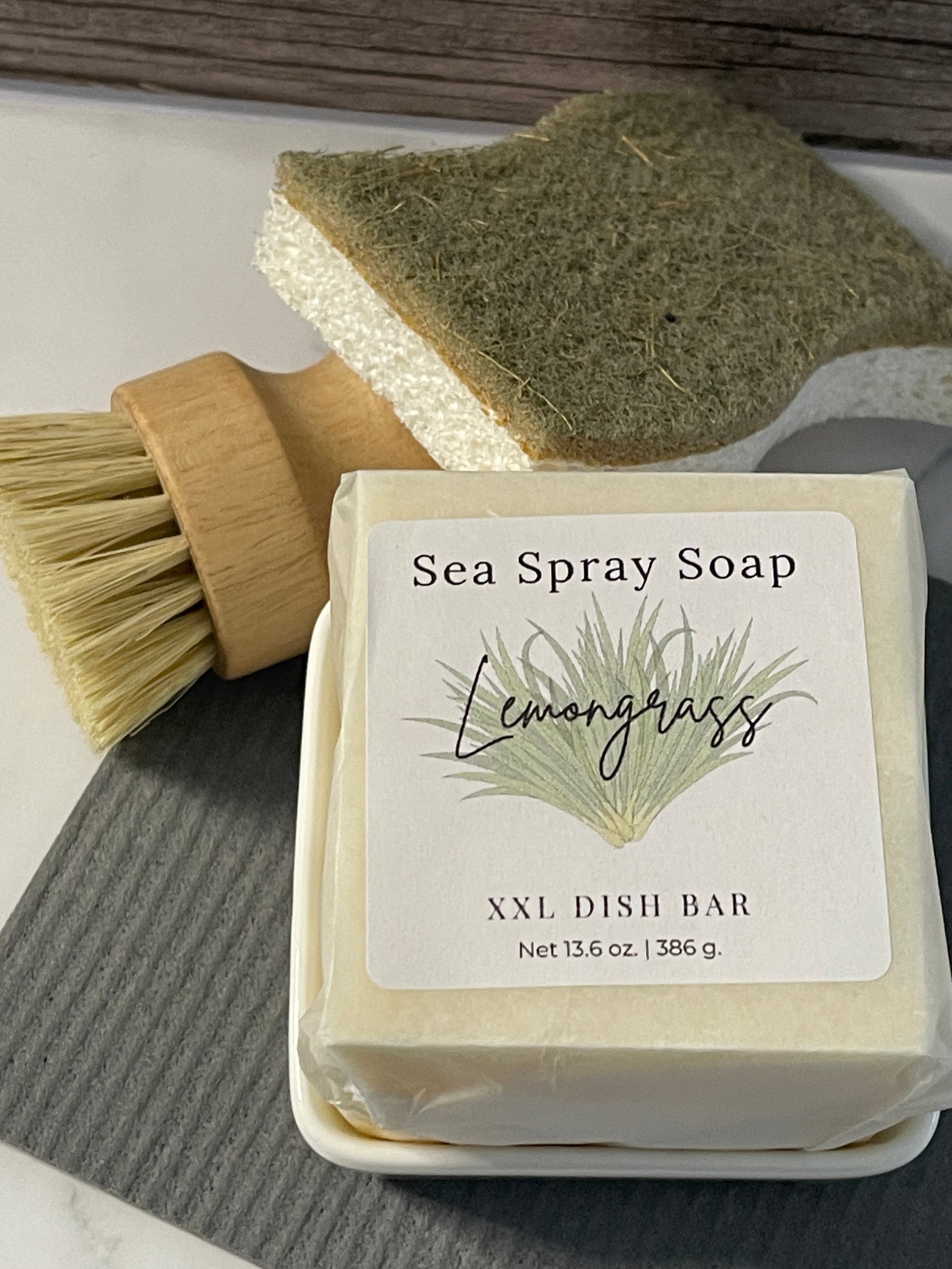 Sea Spray Soap dish soap bar with brush and packaging on a textured surface