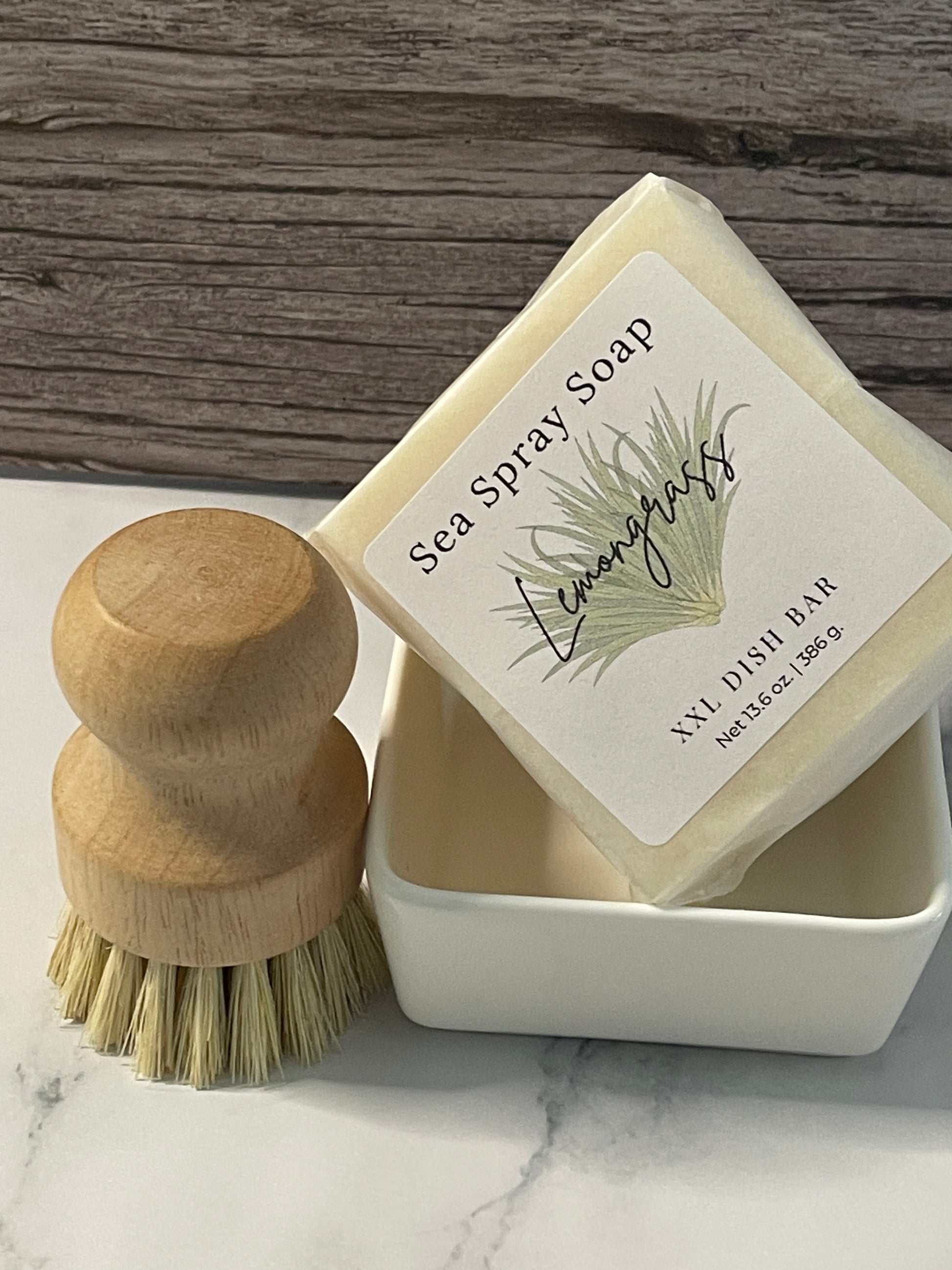 Bar of soap with a wooden brush on a marble surface