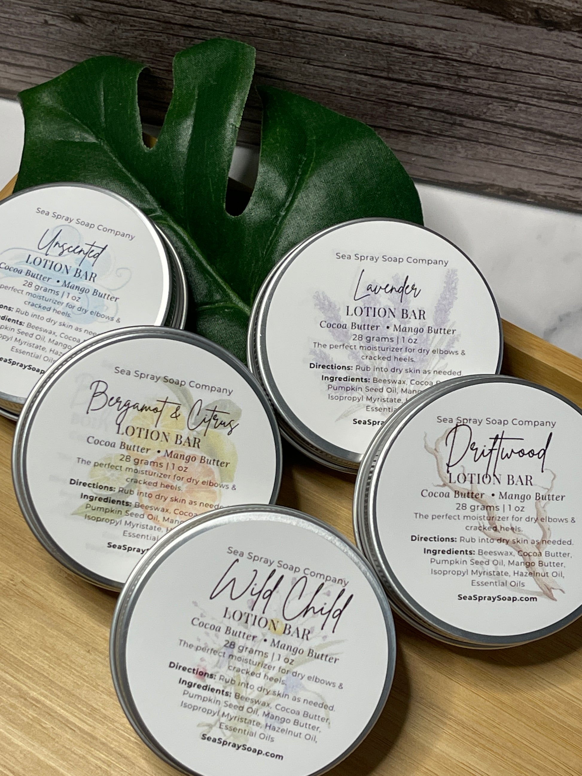Collection of lotion bars with labels on a wooden surface
