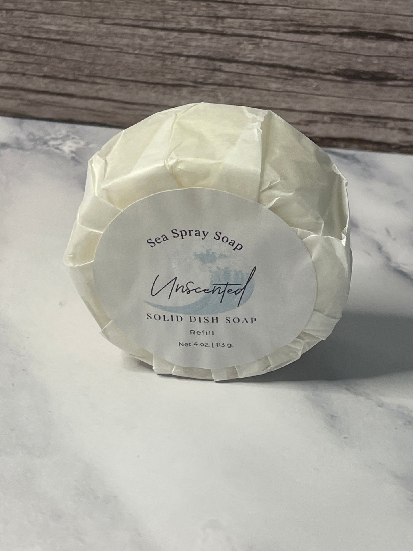 Solid dish soap bar with a label on a marble surface