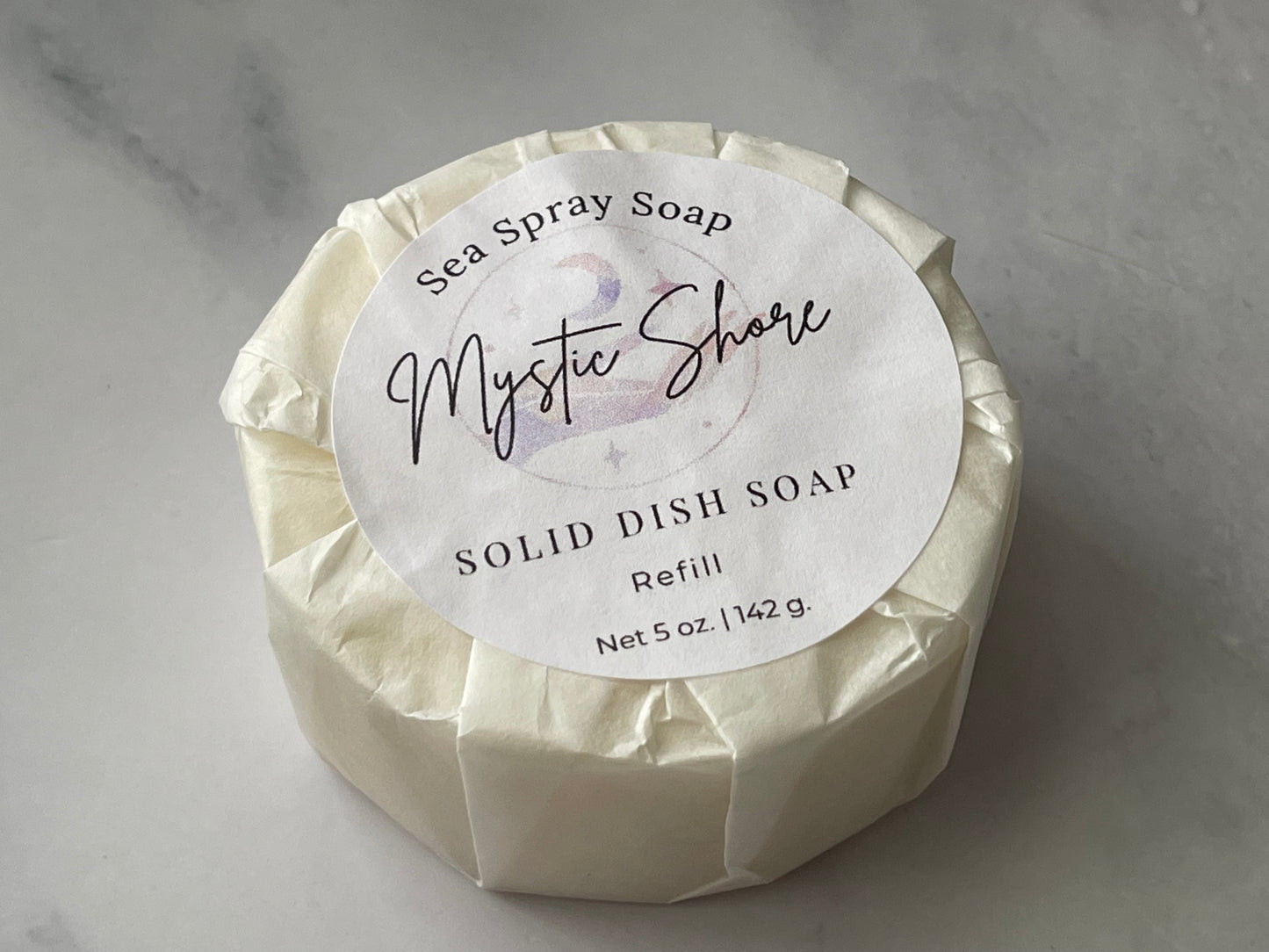 Solid dish soap refill with 'Mystic Shore' label on a gray background