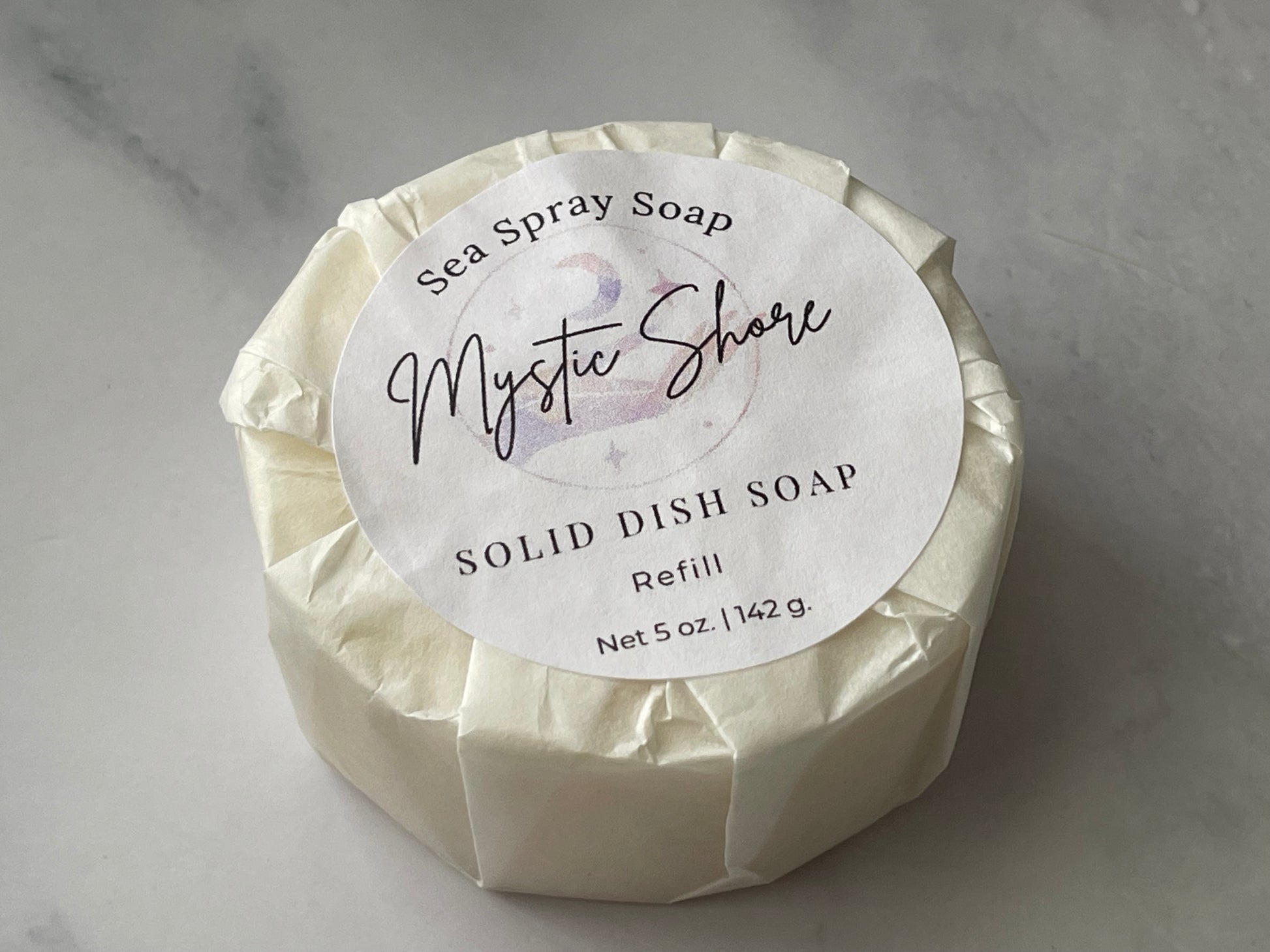 Solid dish soap refill with 'Mystic Shore' label on a gray background