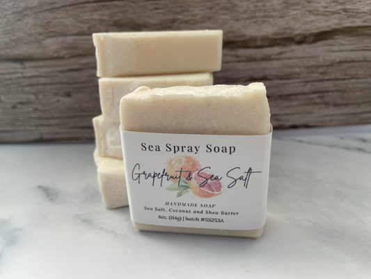 Sea Spray Soap with a label on a marble surface and wooden background