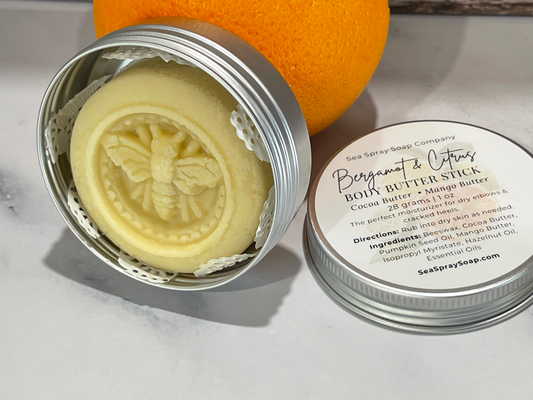 Beeswax product in a metal container with a label on a light background