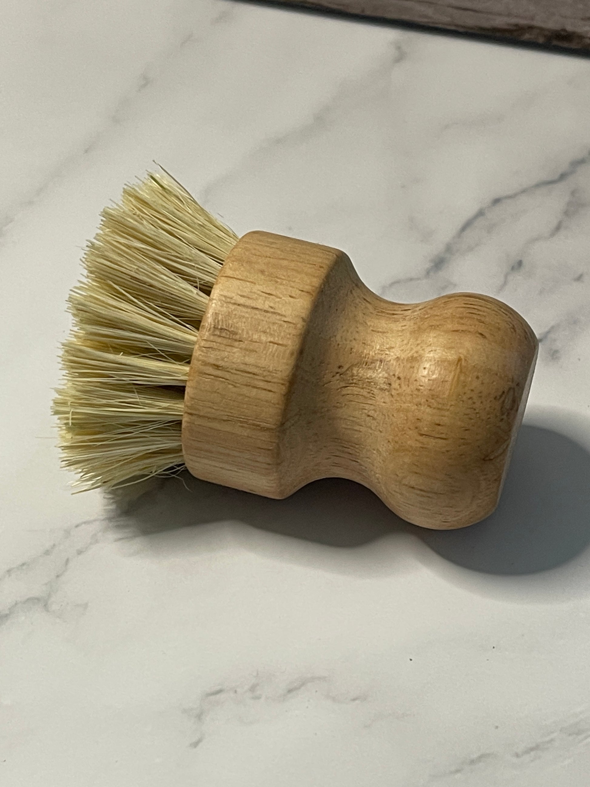 Wooden brush with bristles on a marble surface