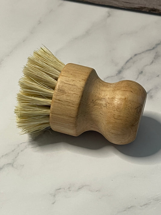 Wooden brush with bristles on a marble surface