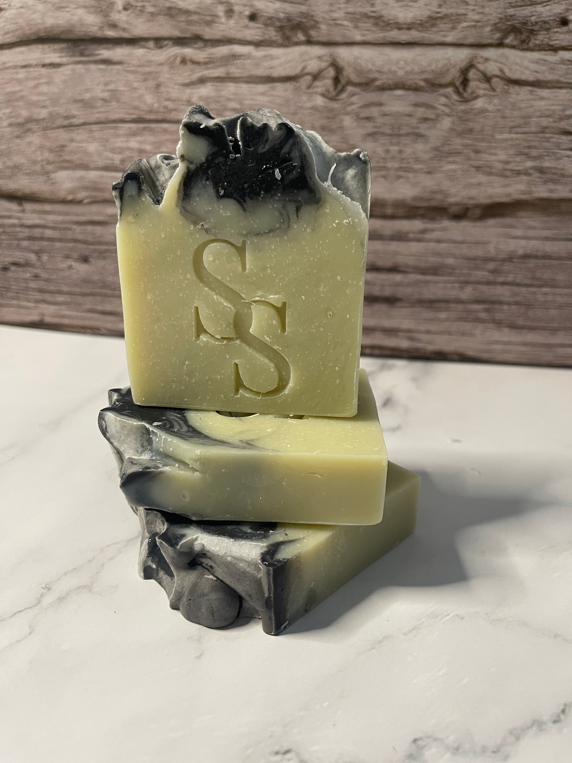 Bar of soap with black and white contrasting sides on a marble surface