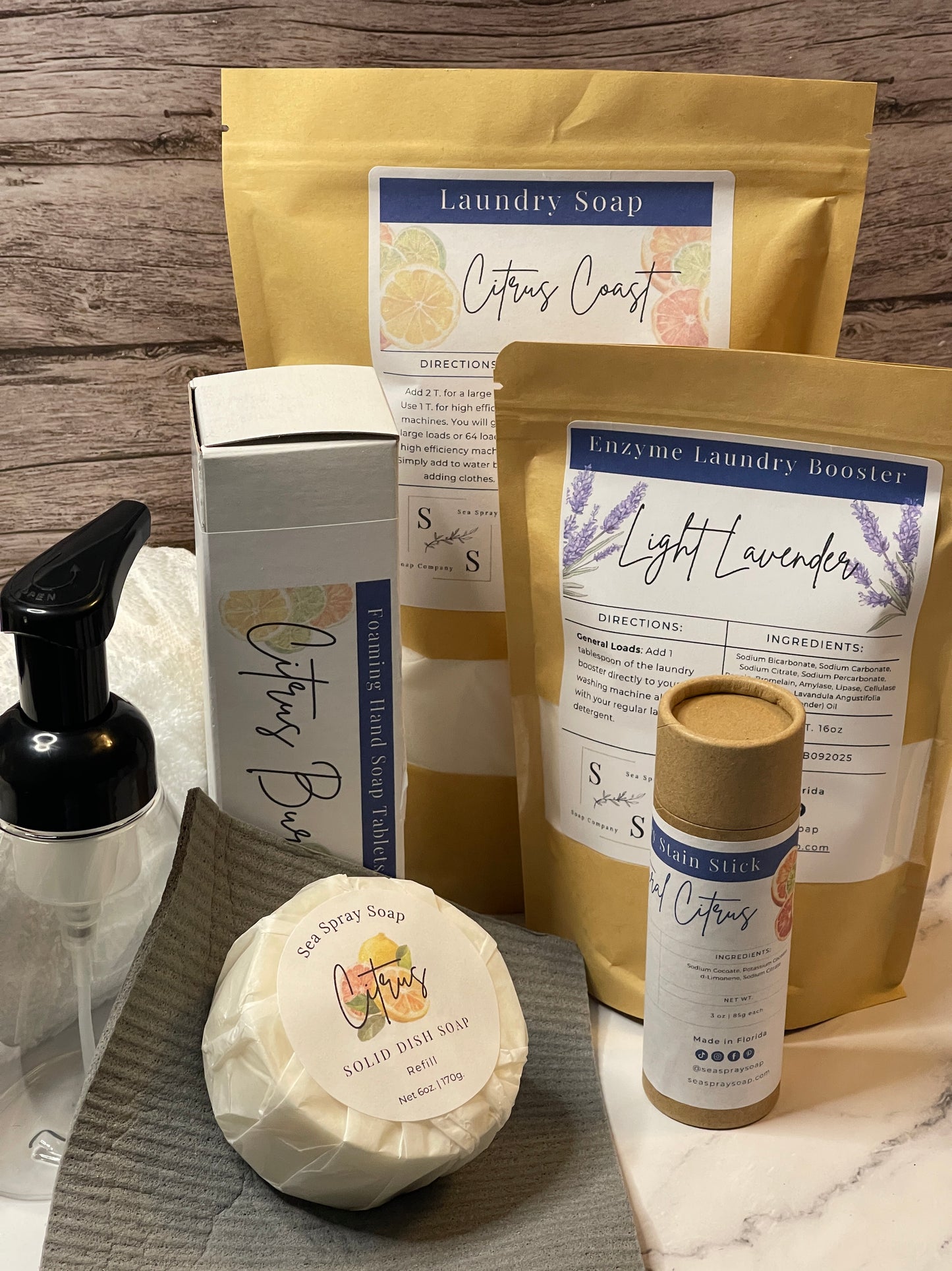 Collection of soap products including bars and packaging on a wooden surface