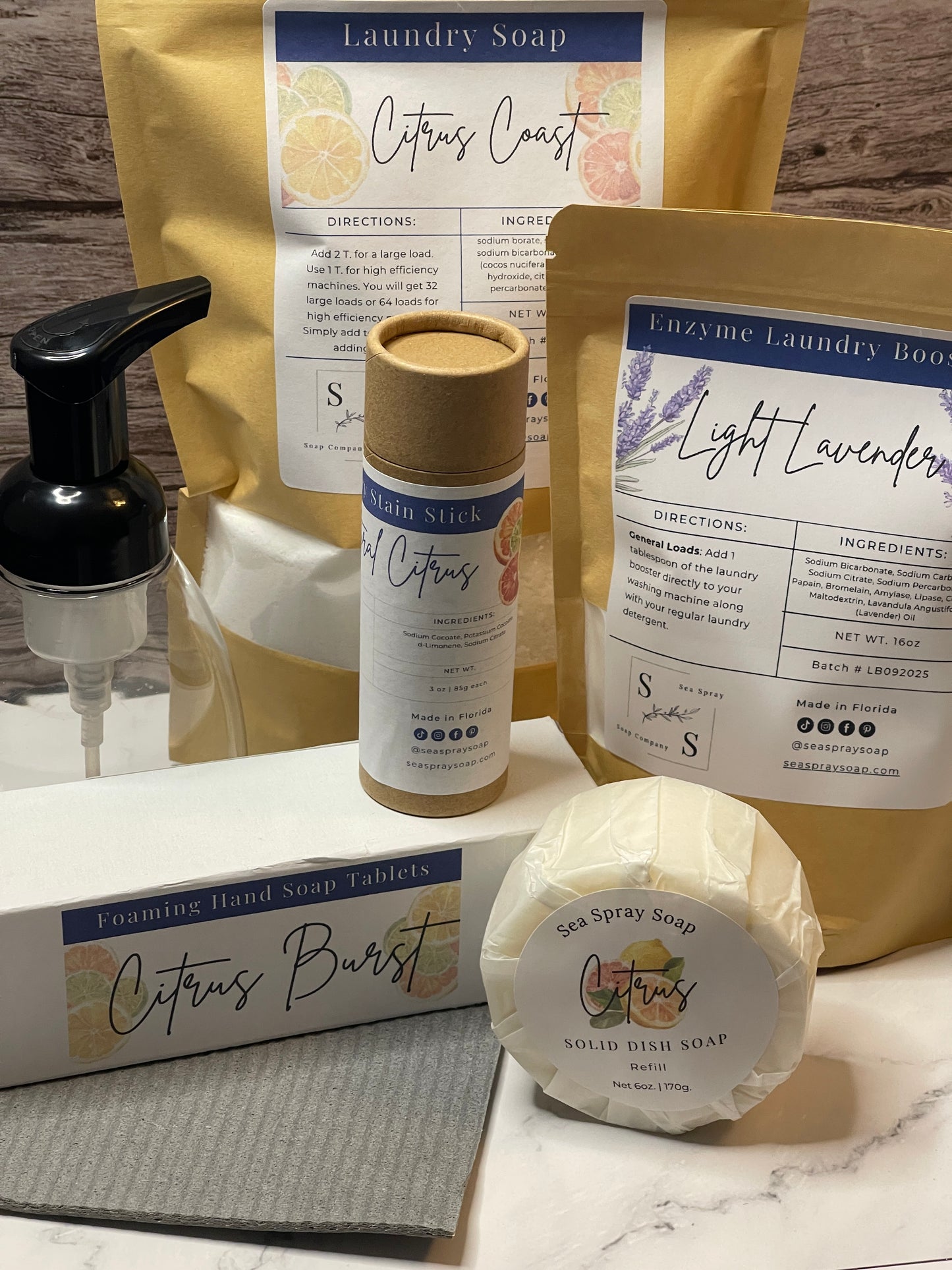 Collection of soap products including a bar, a tube, and a bag on a marble surface.