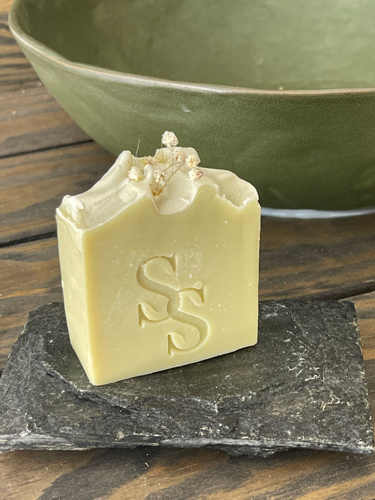 Cooling cucumber soap bar with natural ingredients on marble background