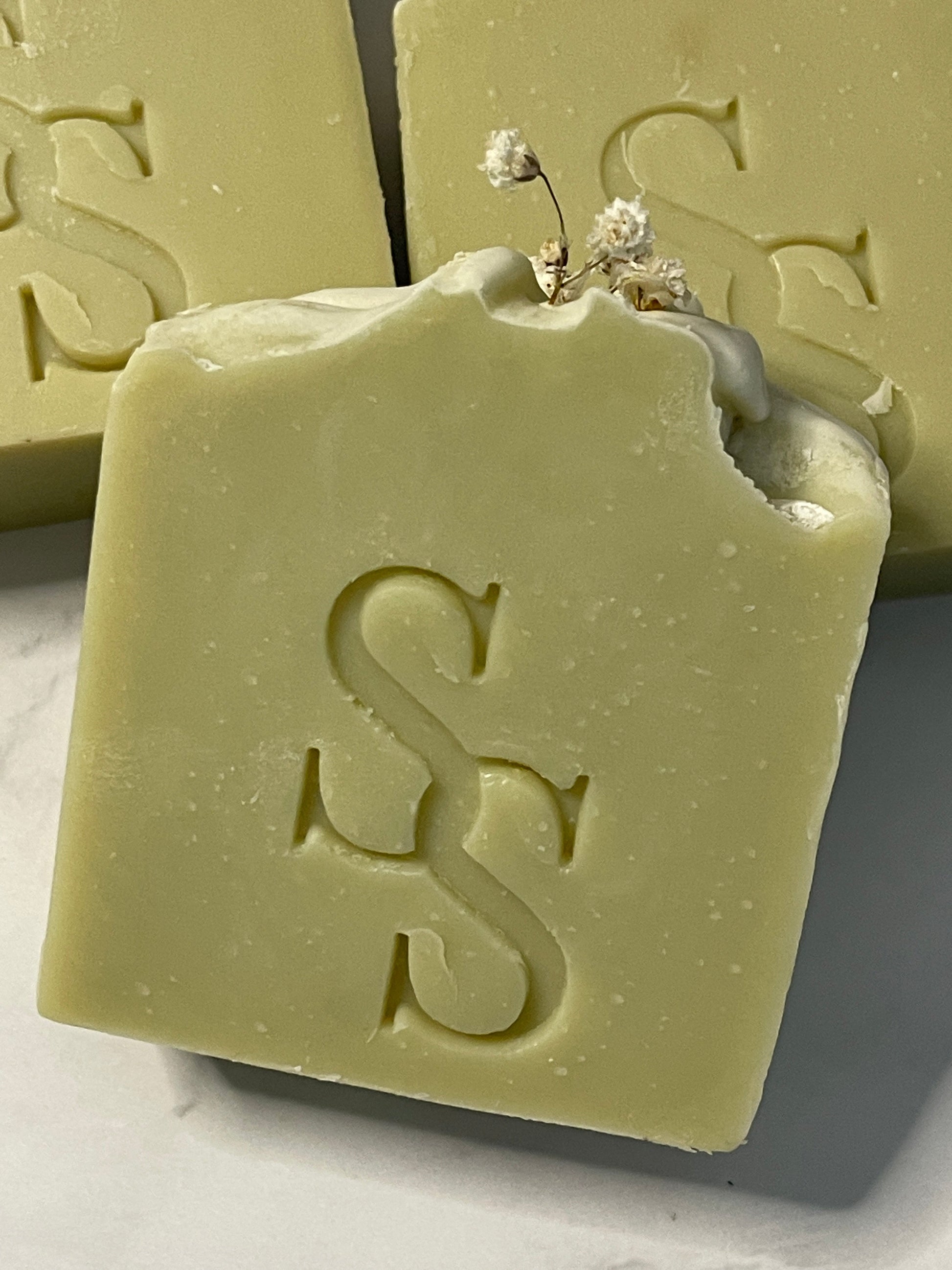 Green soap bar with a logo on a white background