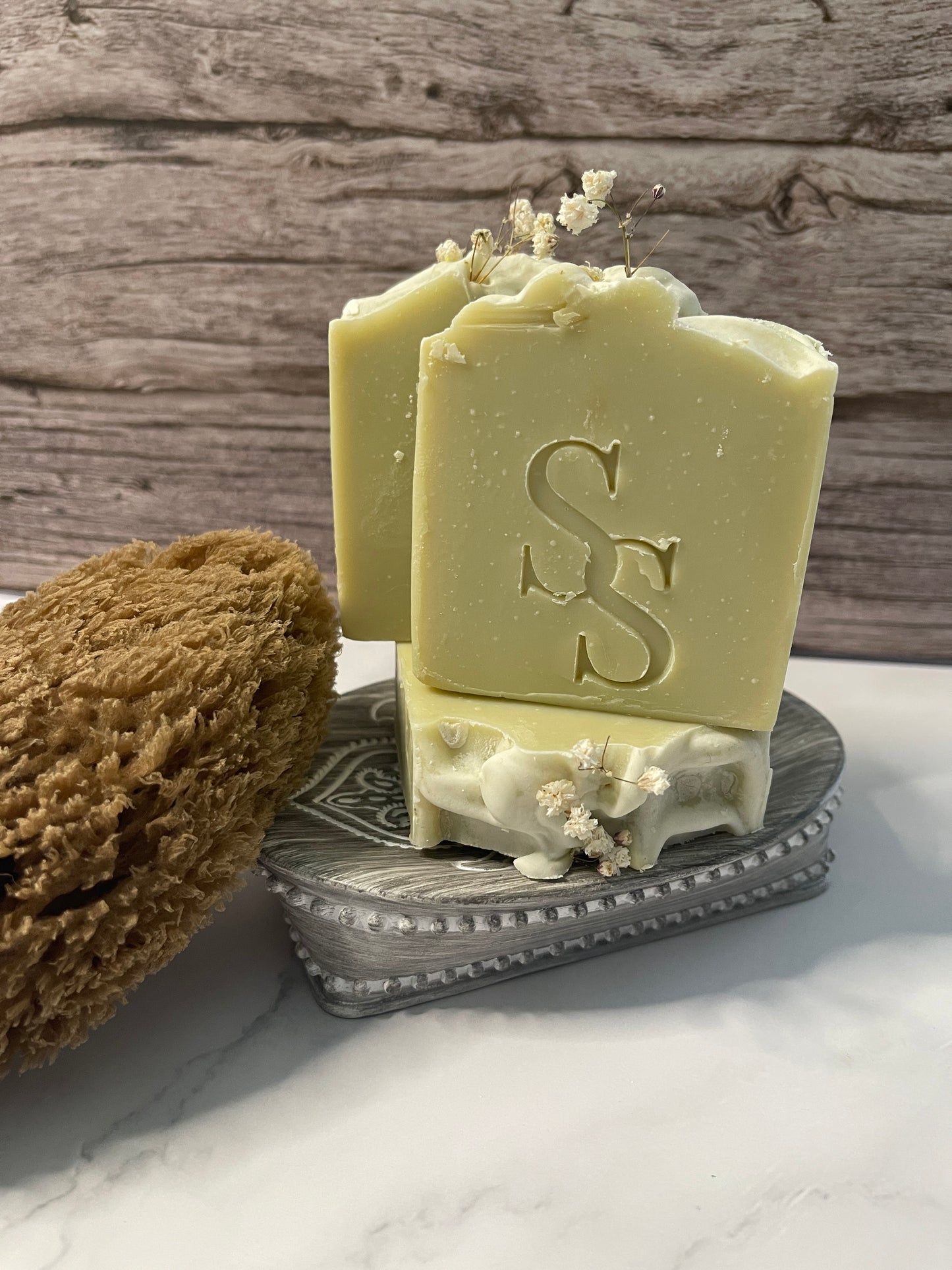 Bar of soap with a logo on a wooden surface