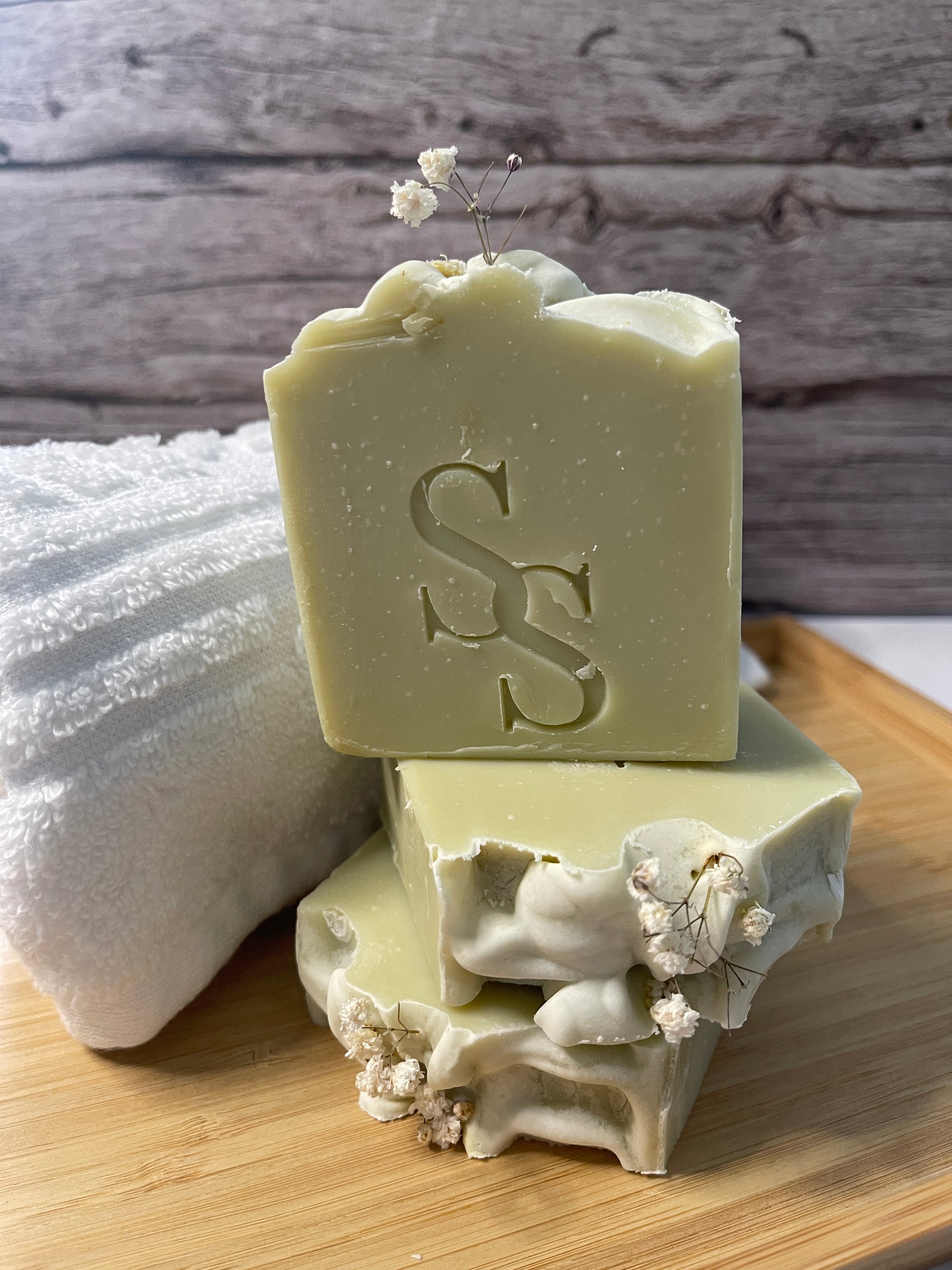 Bar of soap with decorative design on a wooden surface