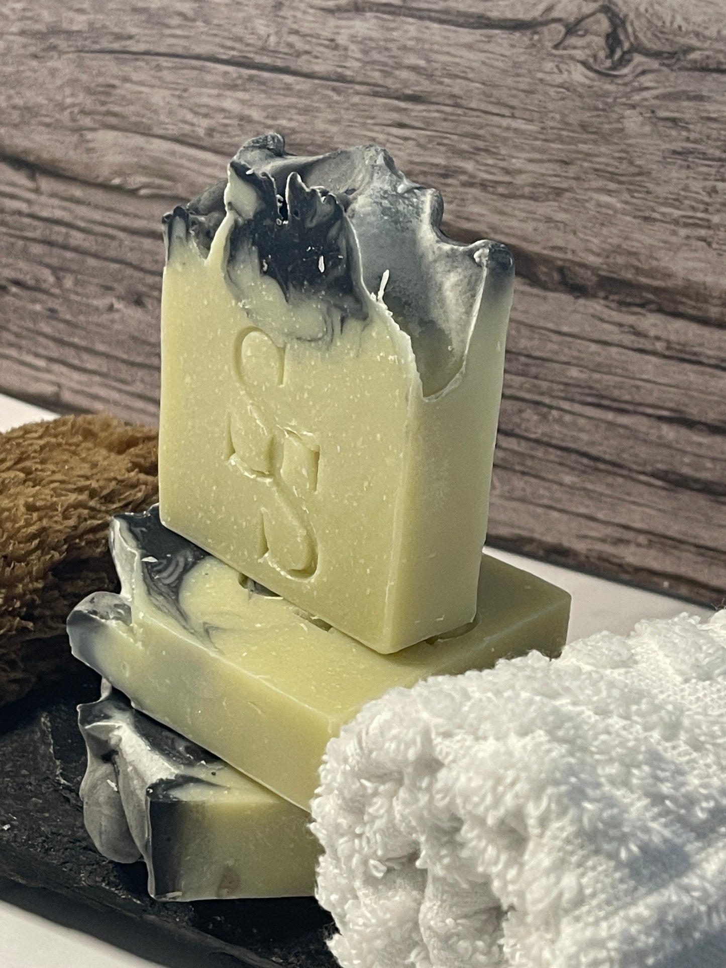 Bar of soap with a visible brand logo on a wooden surface