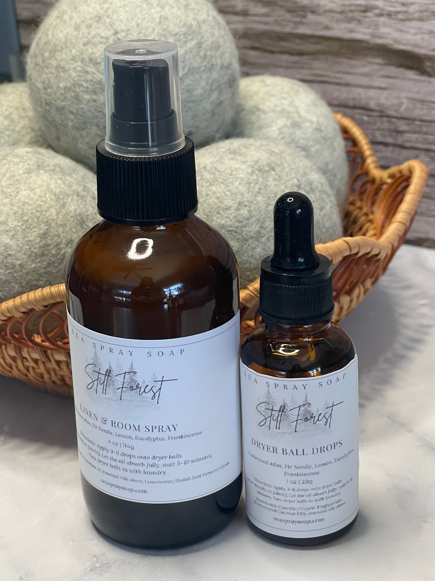 Two bottles of a product with labels on a textured surface.