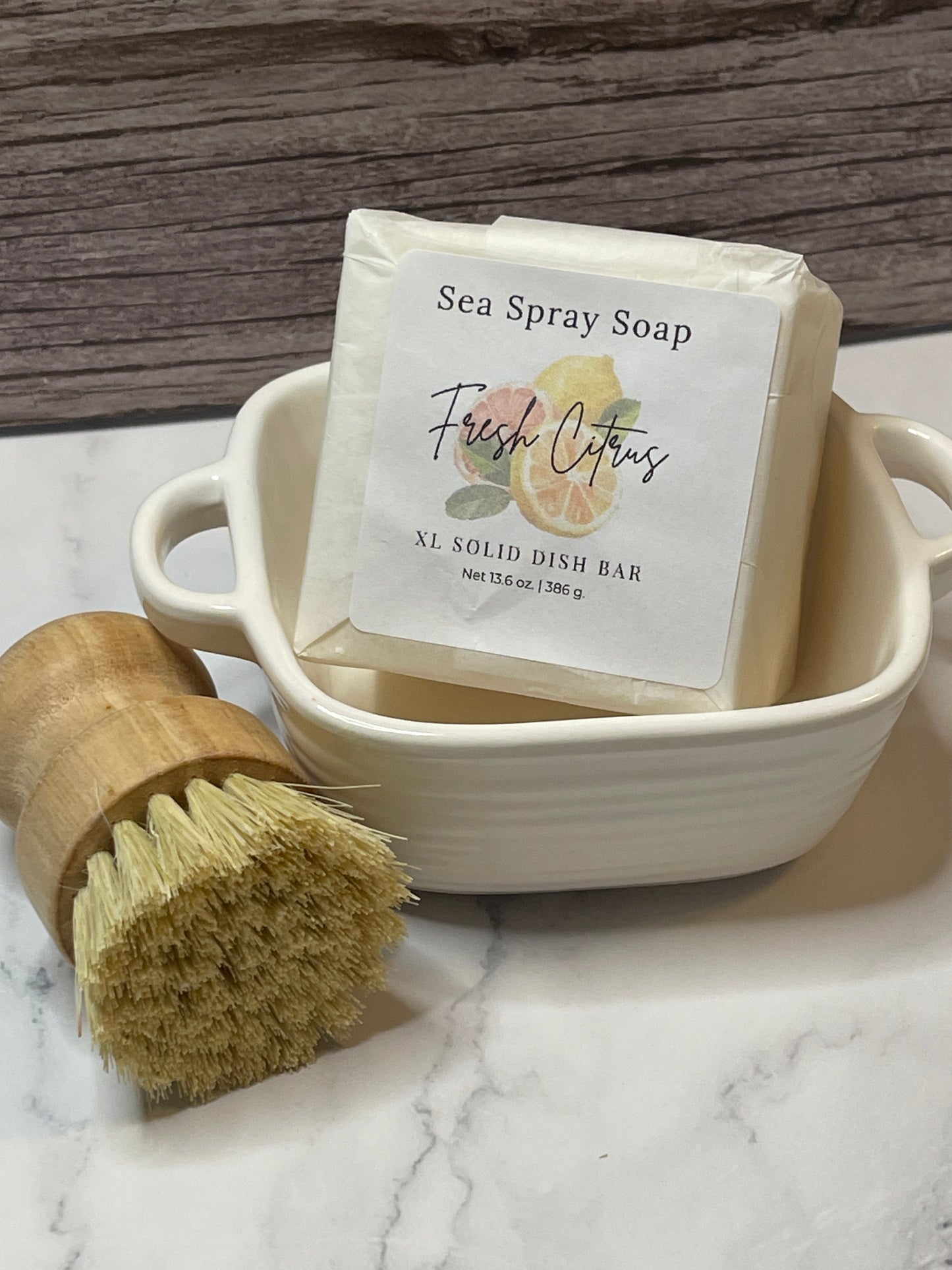 Sea spray soap bar with a wooden brush on a marble surface