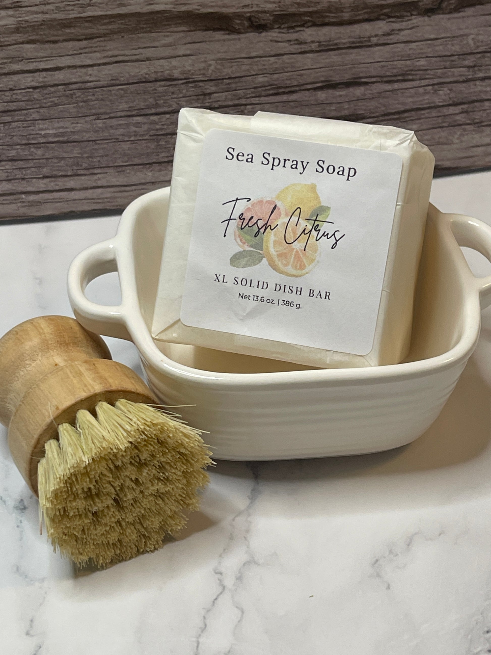 Sea spray soap bar with a wooden brush on a marble surface