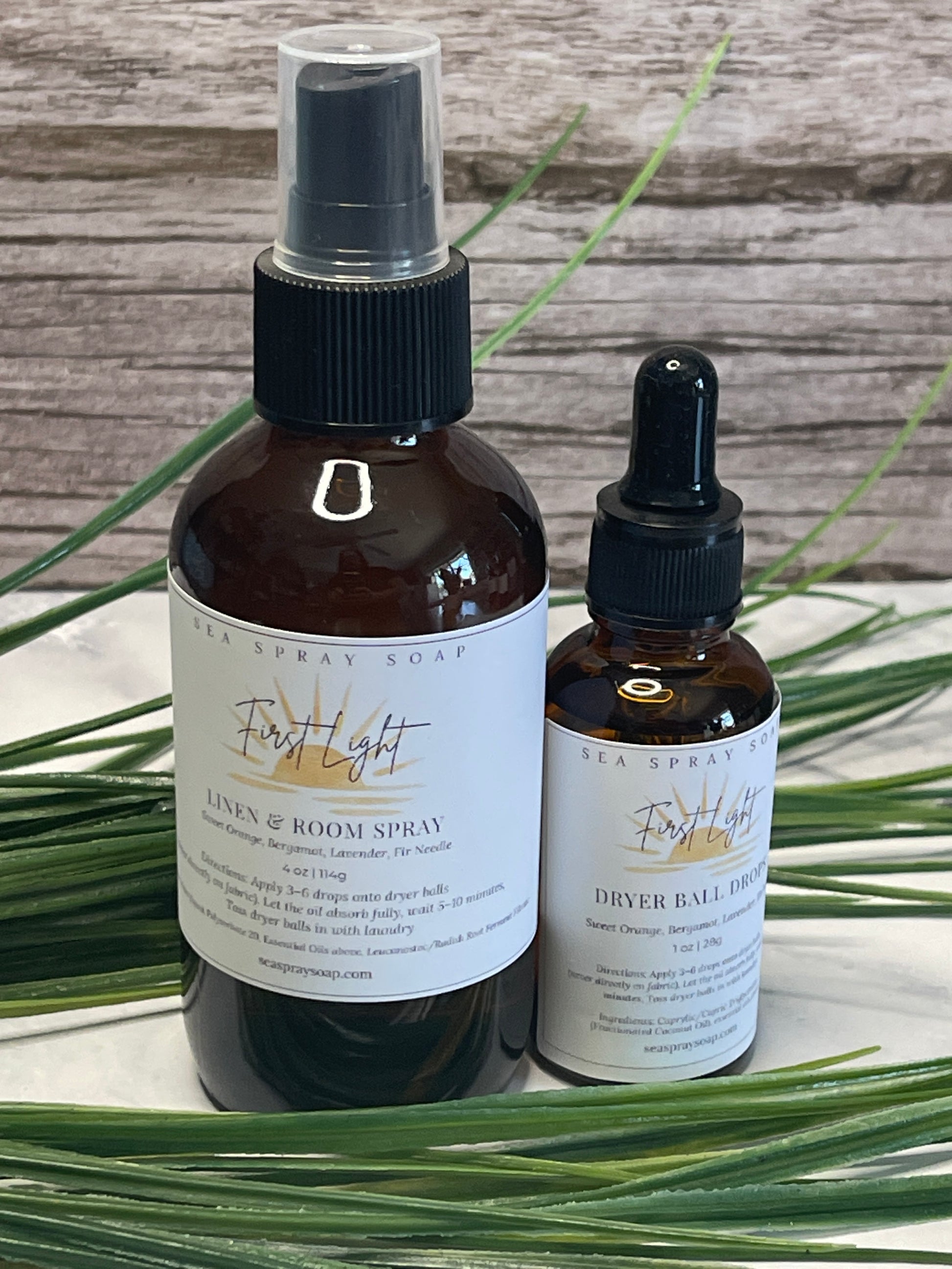 Two bottles of a product with labels on a wooden surface with plants in the background