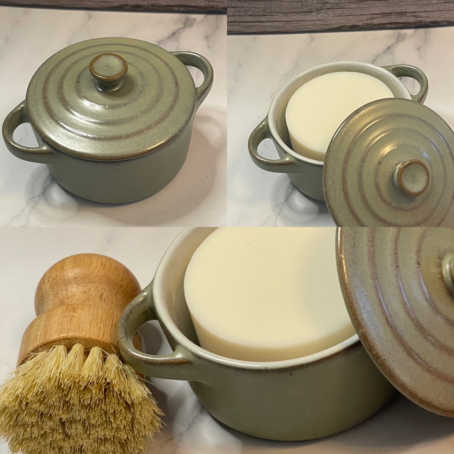Two ceramic containers with lids and a wooden brush on a marble surface.