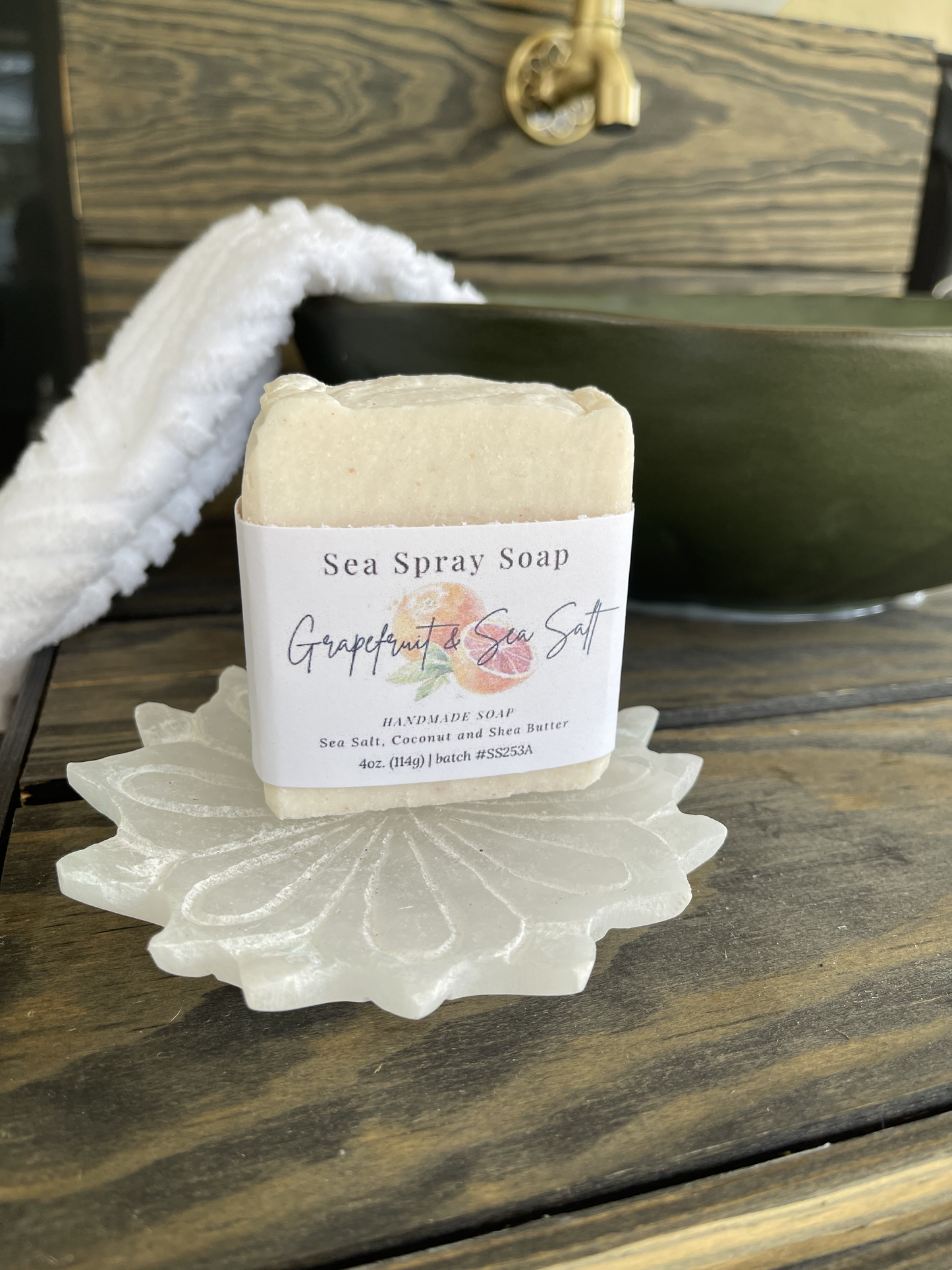 Bar of Sea Spray Soap on a decorative soap dish with a wooden background