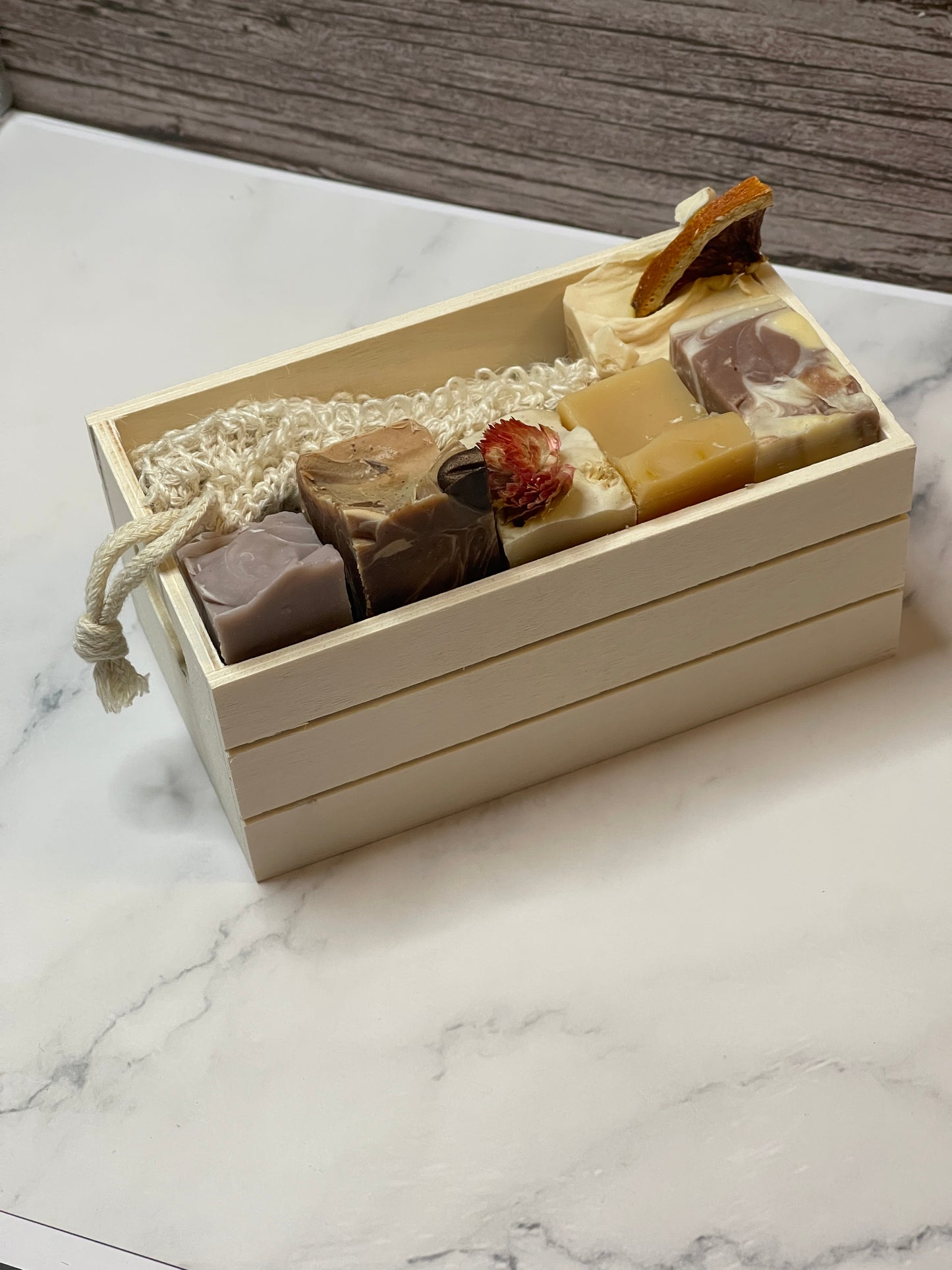 Set of soaps in a decorative box on a marble surface