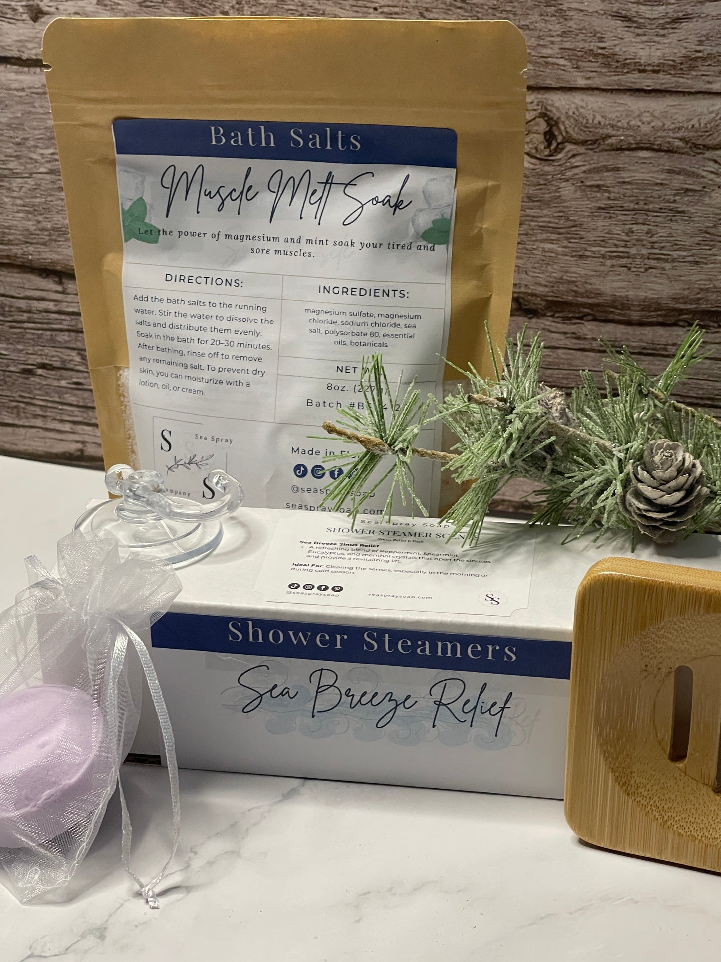 Bath salts package, shower steamers, and decorative items on a wooden surface