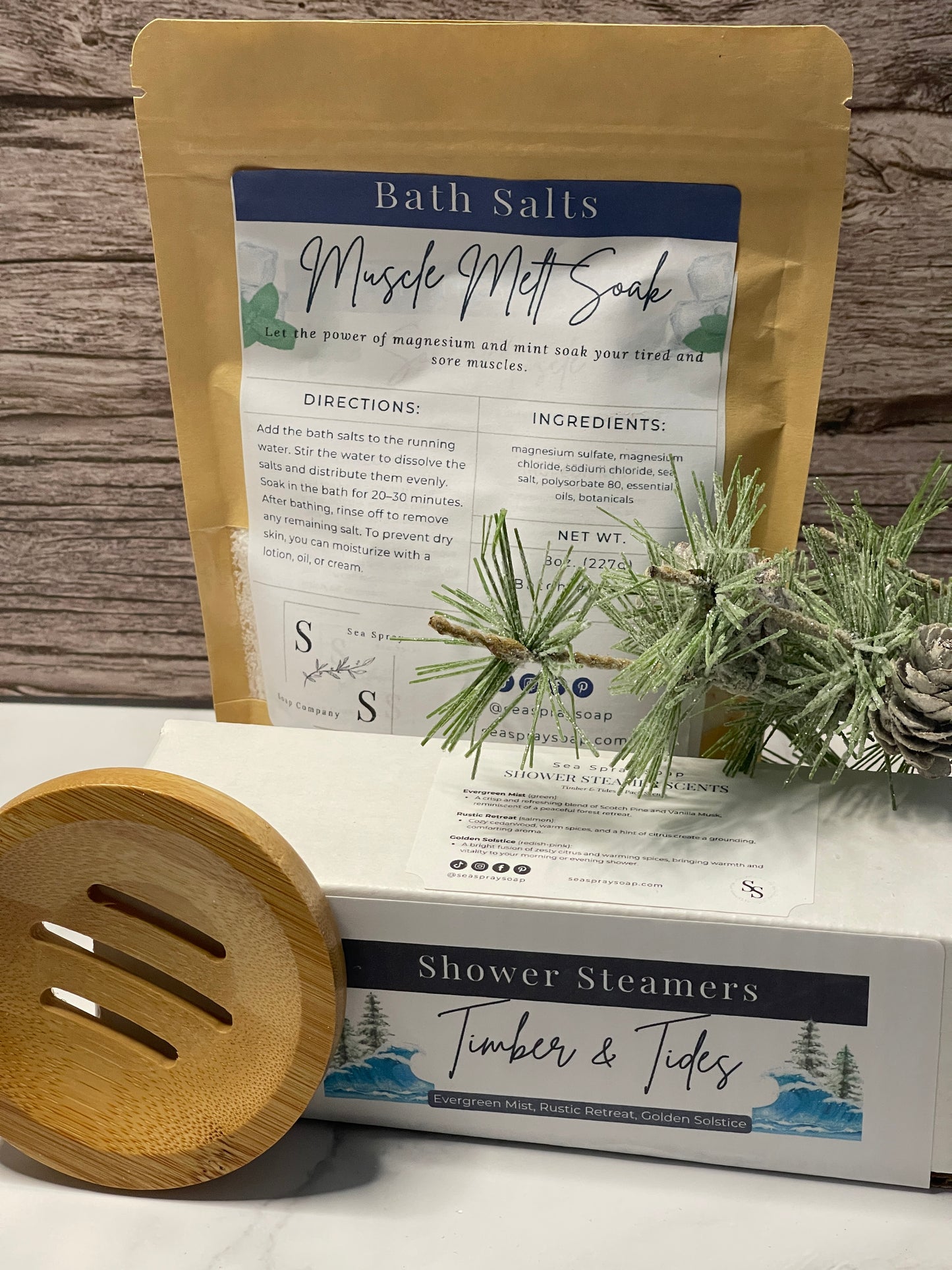 Bath salts package with a wooden spoon and pine branch on a wooden surface