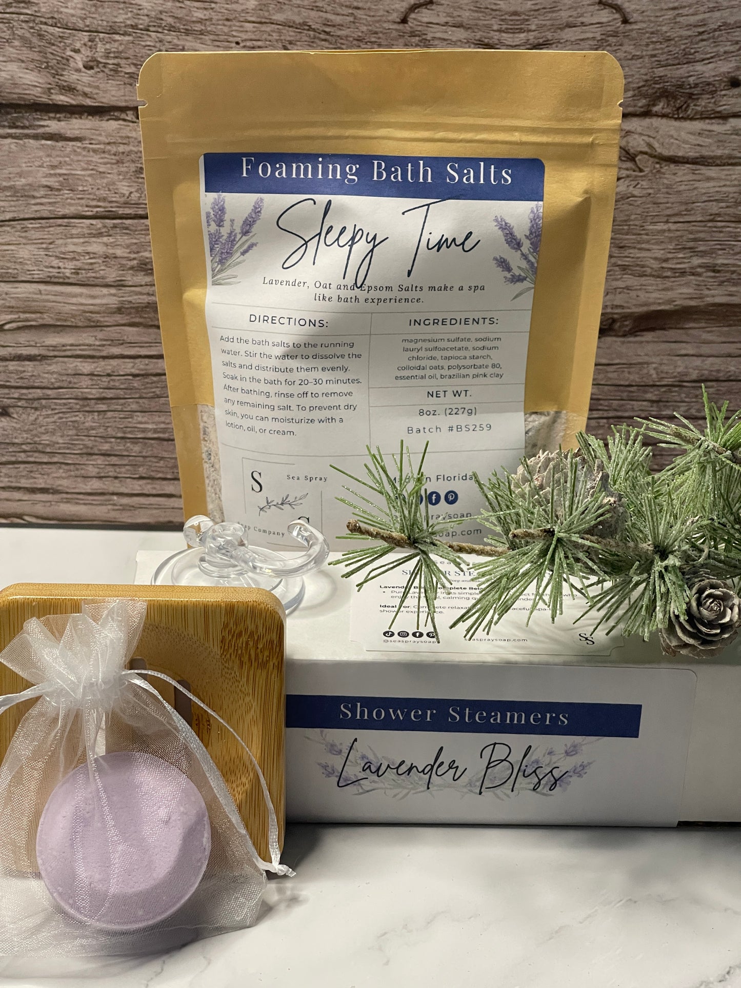 Bath salts packaging with lavender-themed elements on a wooden surface