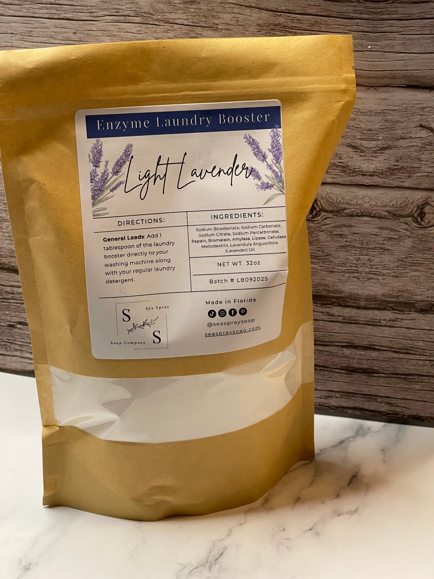 Bag of light lavender laundry booster with a label on a wooden surface