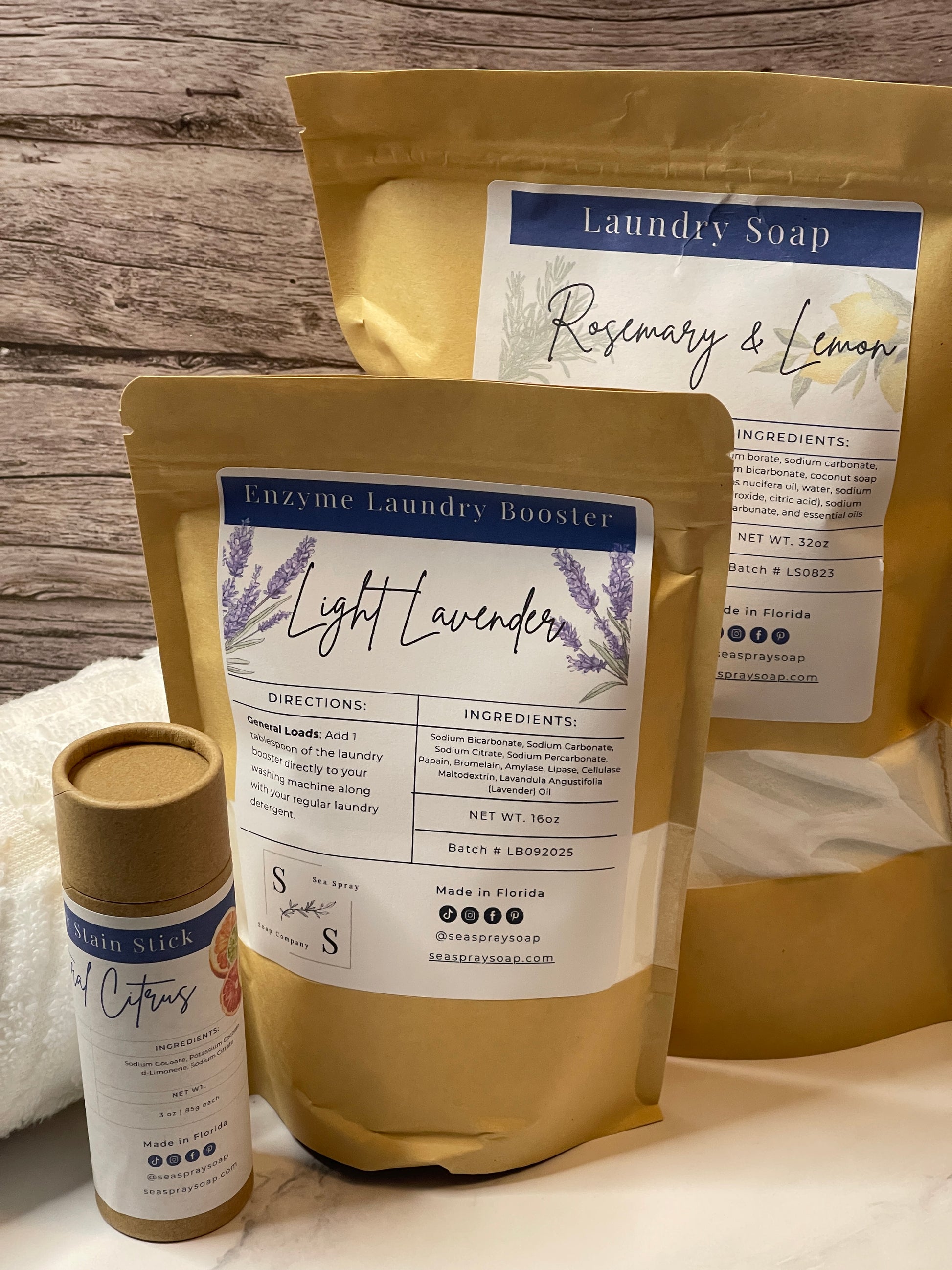 Two packages of laundry soap with labels on a wooden surface