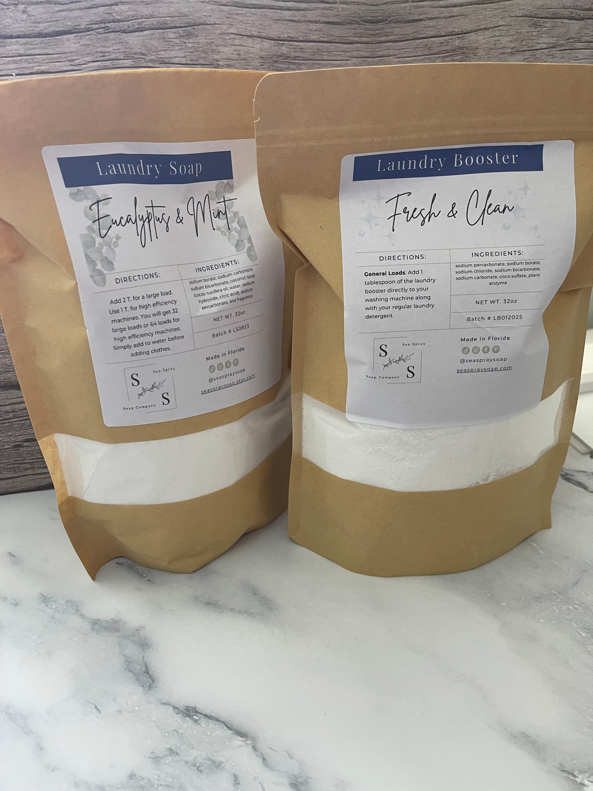 Two brown bags with labels on a marble surface