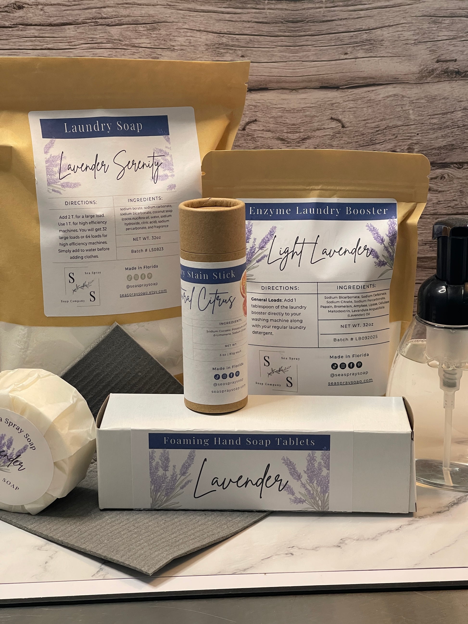 Lavender-themed products including a bottle, box, and packaging on a wooden surface.