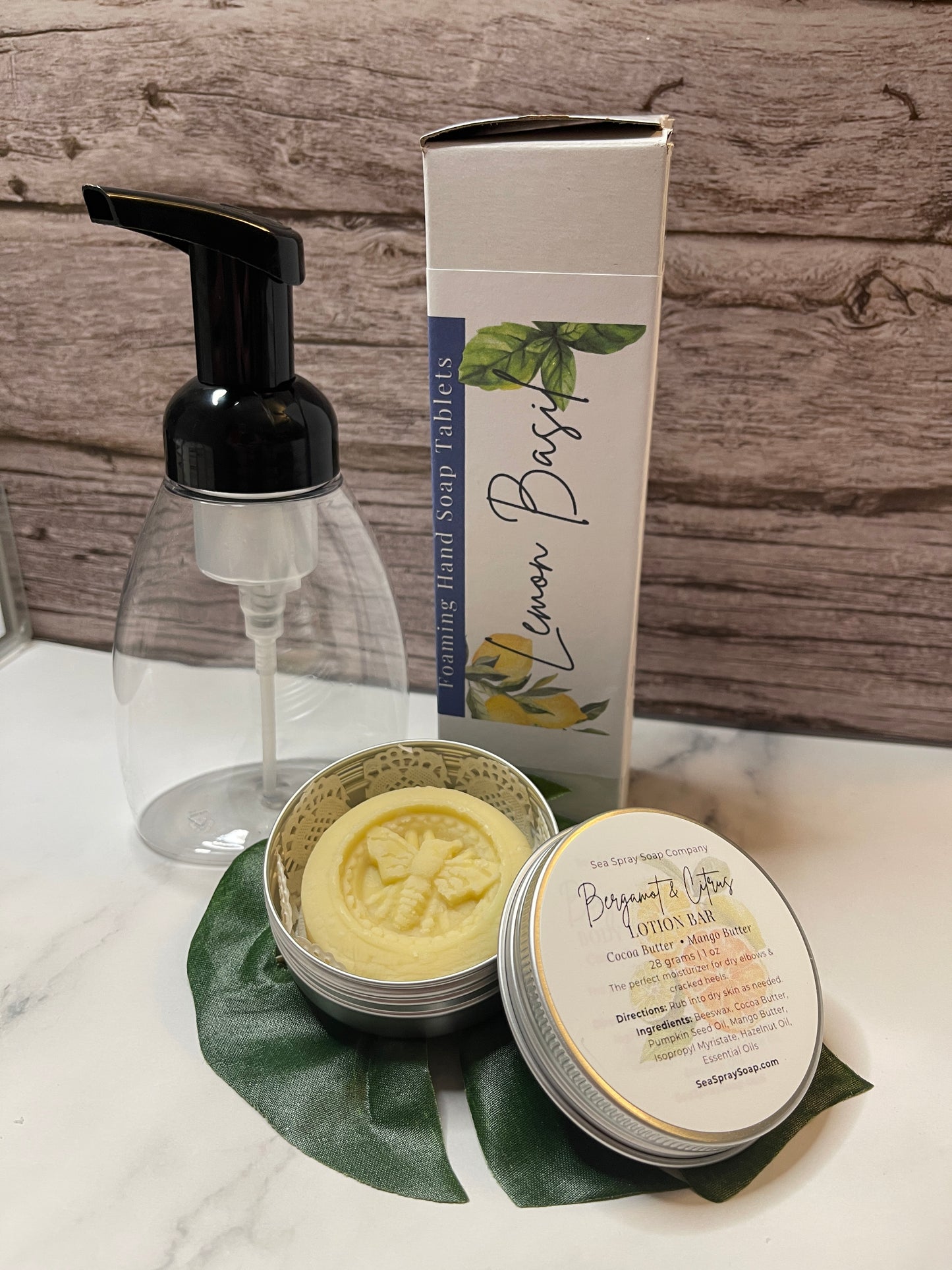 Hand soap set with pump bottle, bar soap, and container on a wooden surface