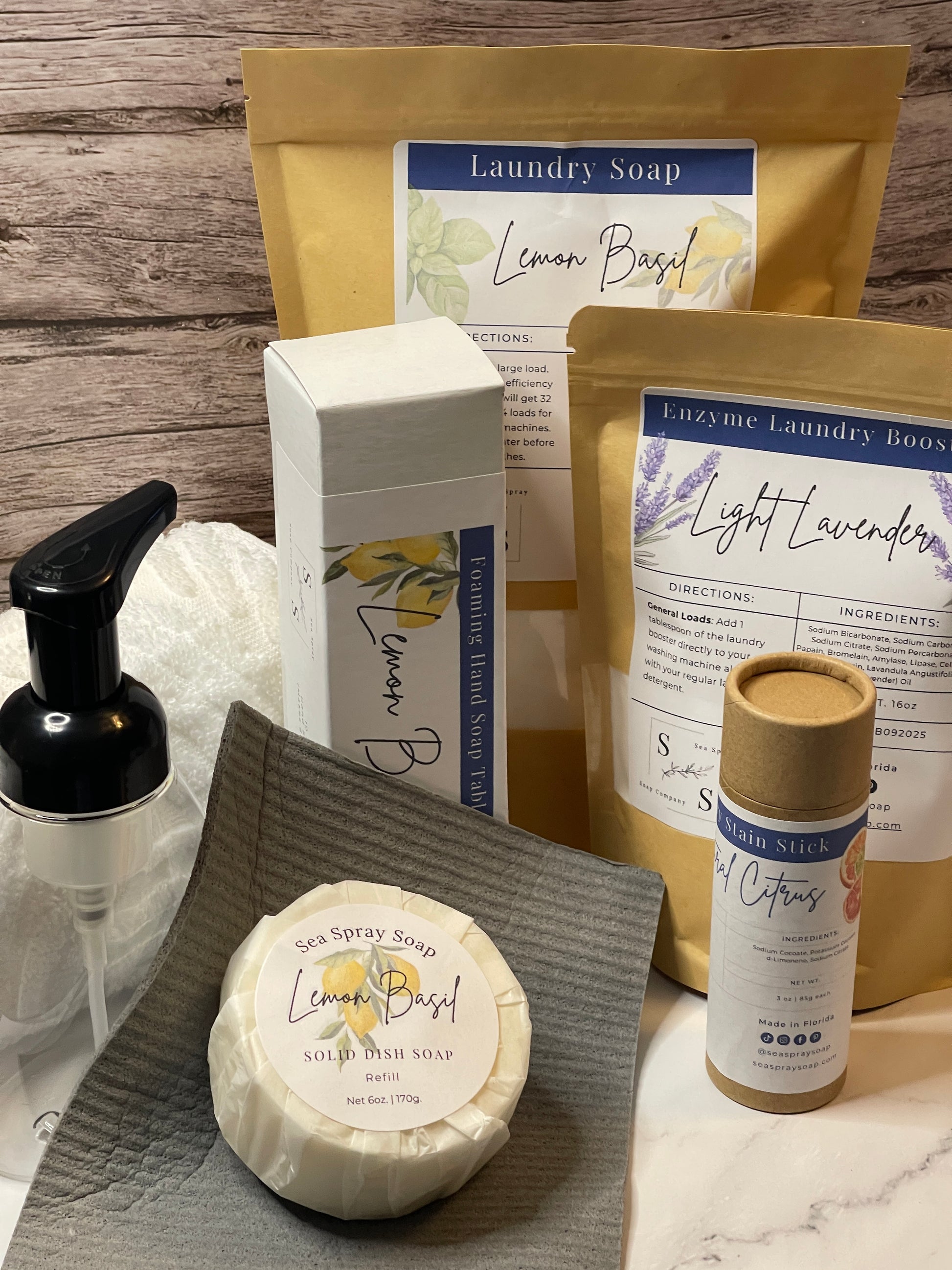 Collection of laundry and cleaning products including soap bars and bottles on a wooden surface.