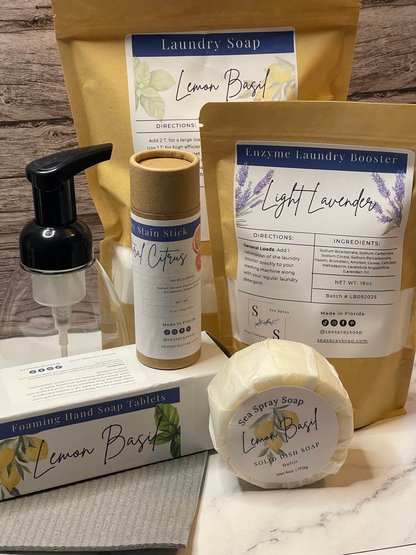 Set of laundry products including a bag, bottle, and bar soap on a wooden surface.