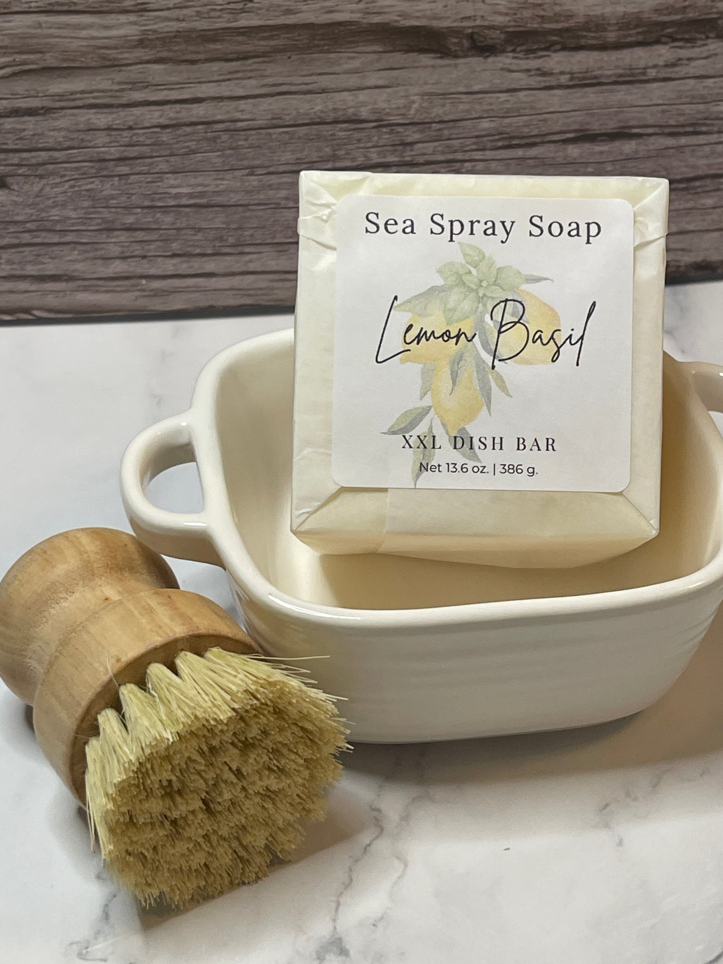 Sea Spray Soap bar with packaging, dish brush, and container on a marble surface