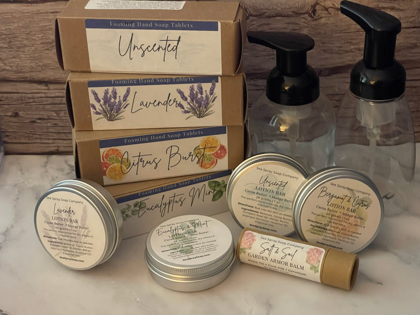 Collection of natural skincare products including soap bars, lotions, and balms on a wooden surface.
