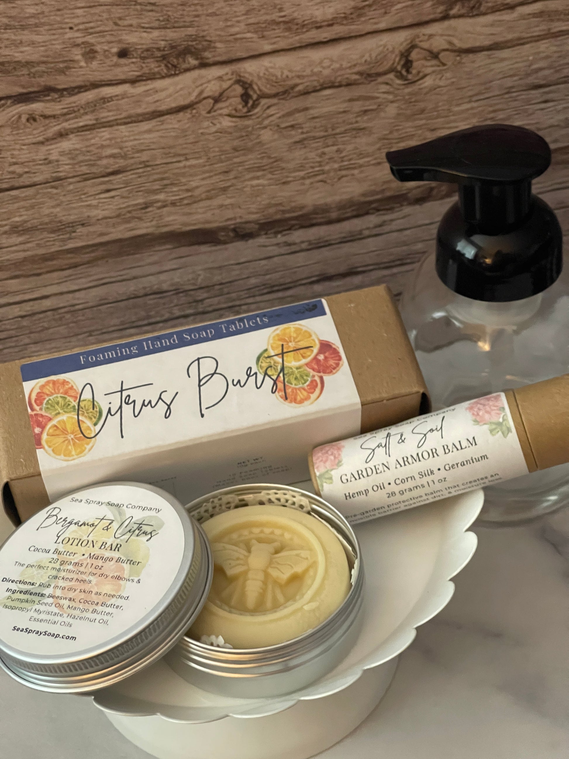 Assorted beauty products including a box, tube, and containers on a wooden surface.