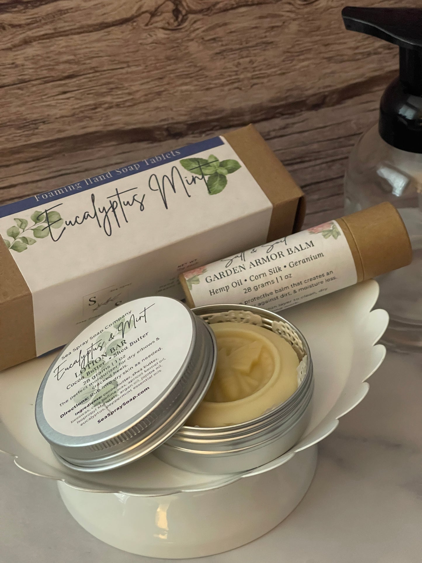 Cosmetic products including a jar, tube, and box on a wooden surface.