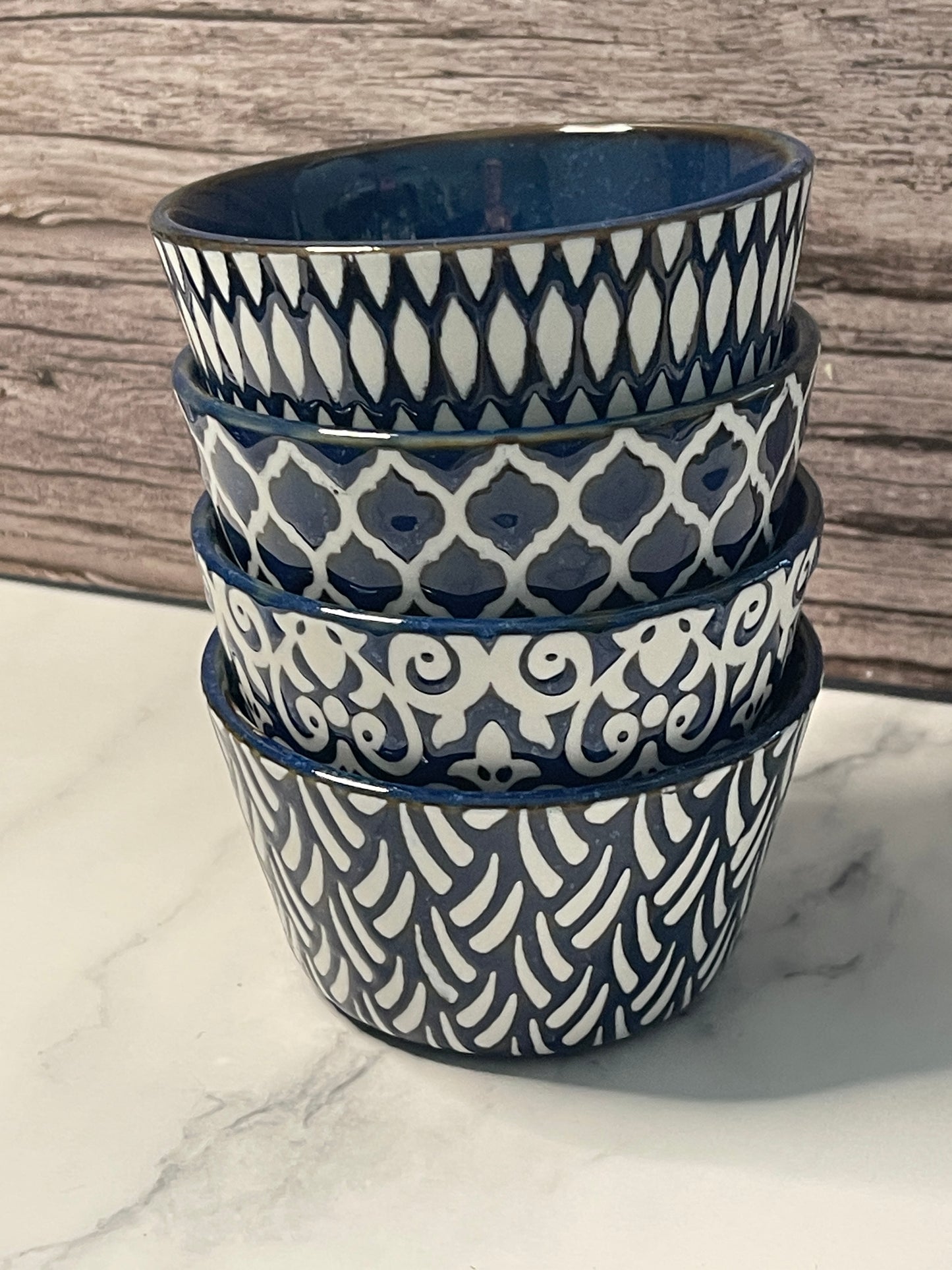 Set of blue and white patterned bracelets on a wooden surface