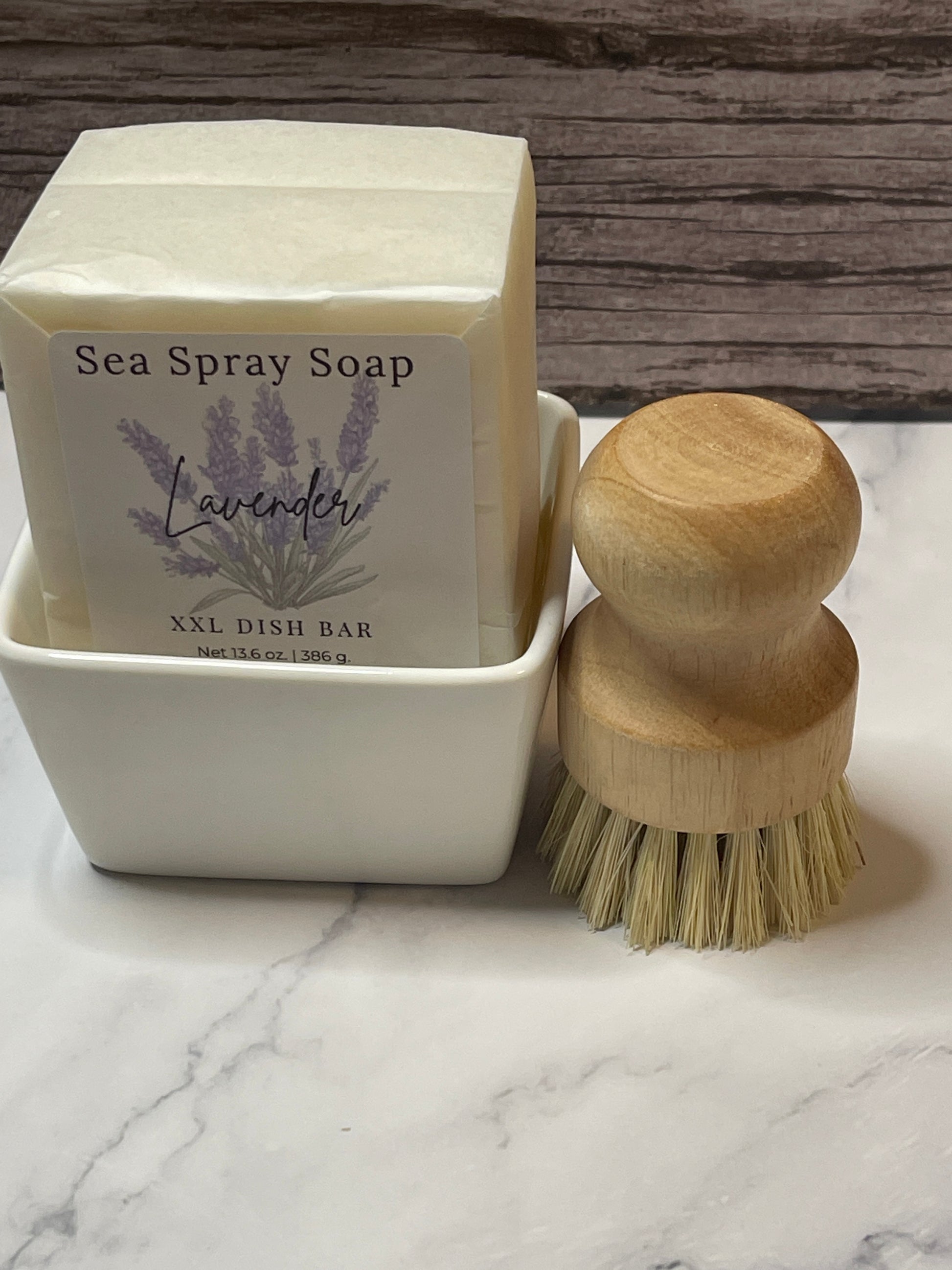 Sea spray soap bar with wooden applicator on a marble surface