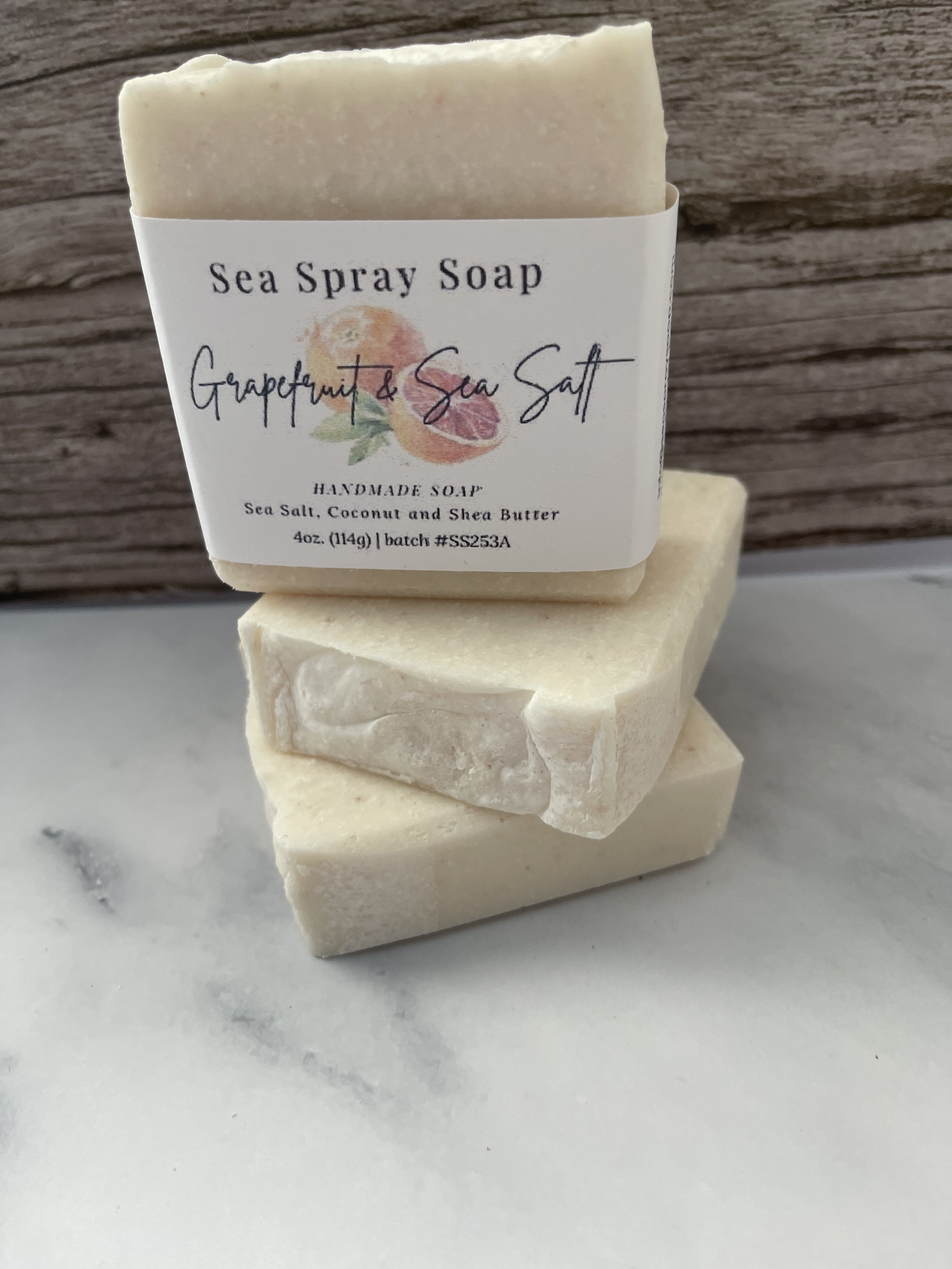 Three bars of Sea Spray Soap with a label on a marble surface.