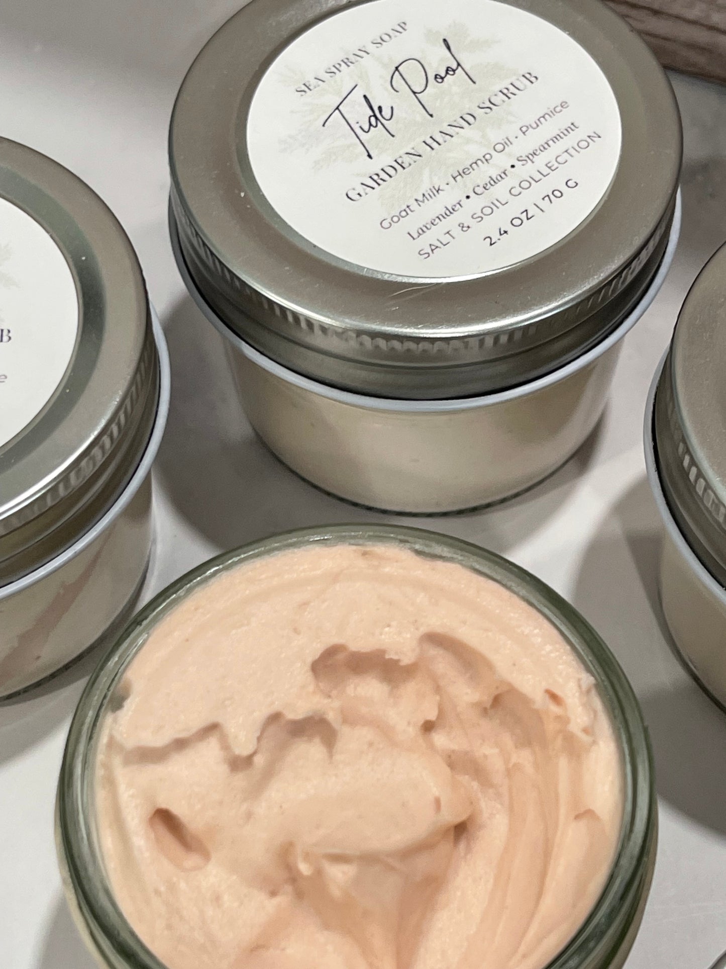 Jars of cream with visible brand name on a reflective surface